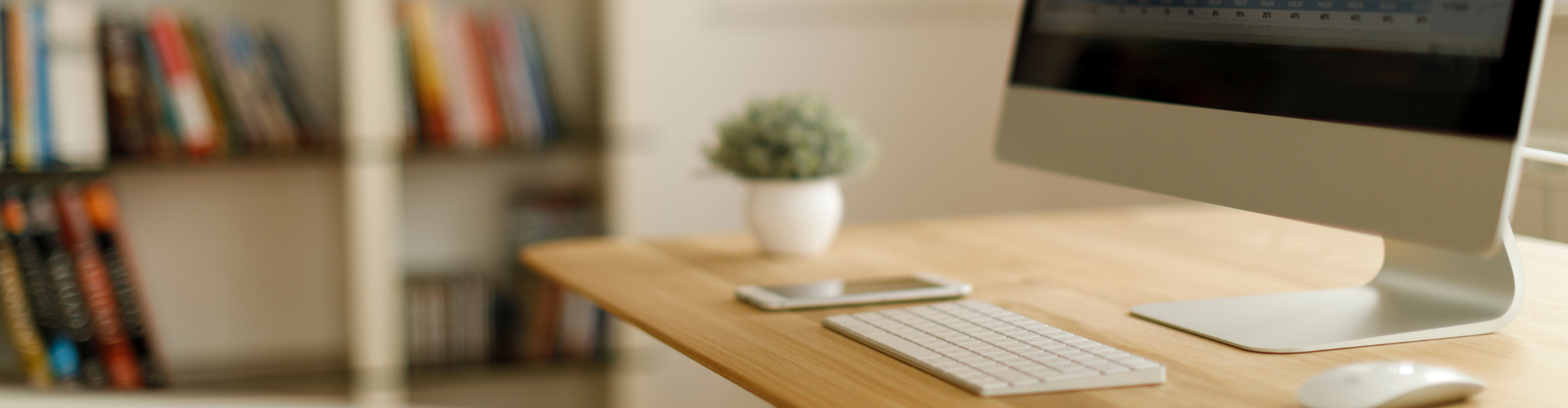 A desk with a computer and a keyboard.