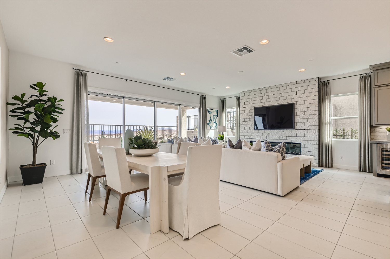 A large living room with a large white couch and a table.