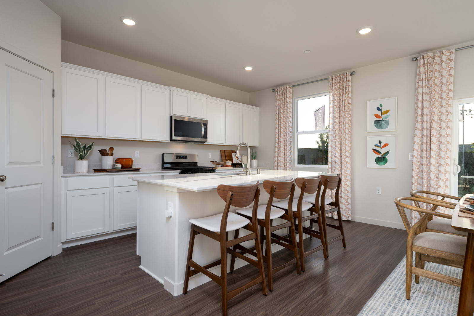 A kitchen with white cabinets.