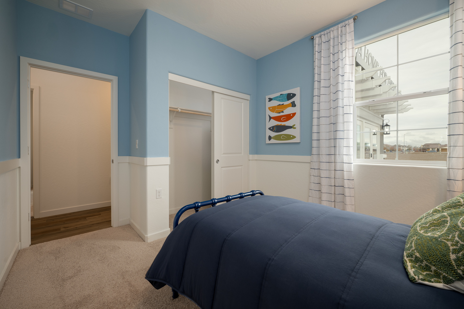 A bedroom with a bed and a window.