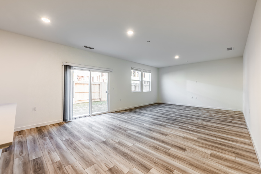 A room with a wood floor and a glass door.