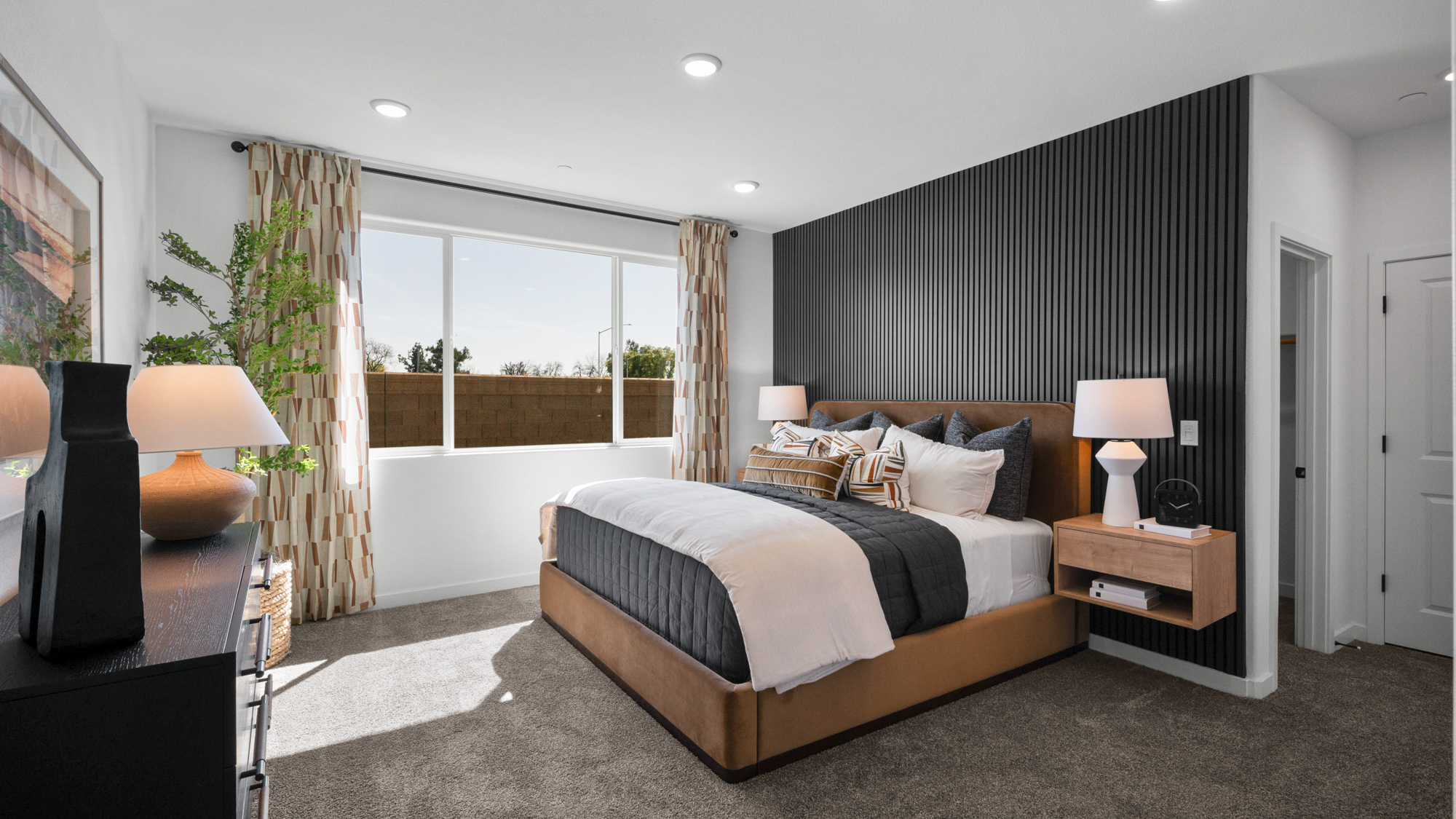 A bedroom with a large window.