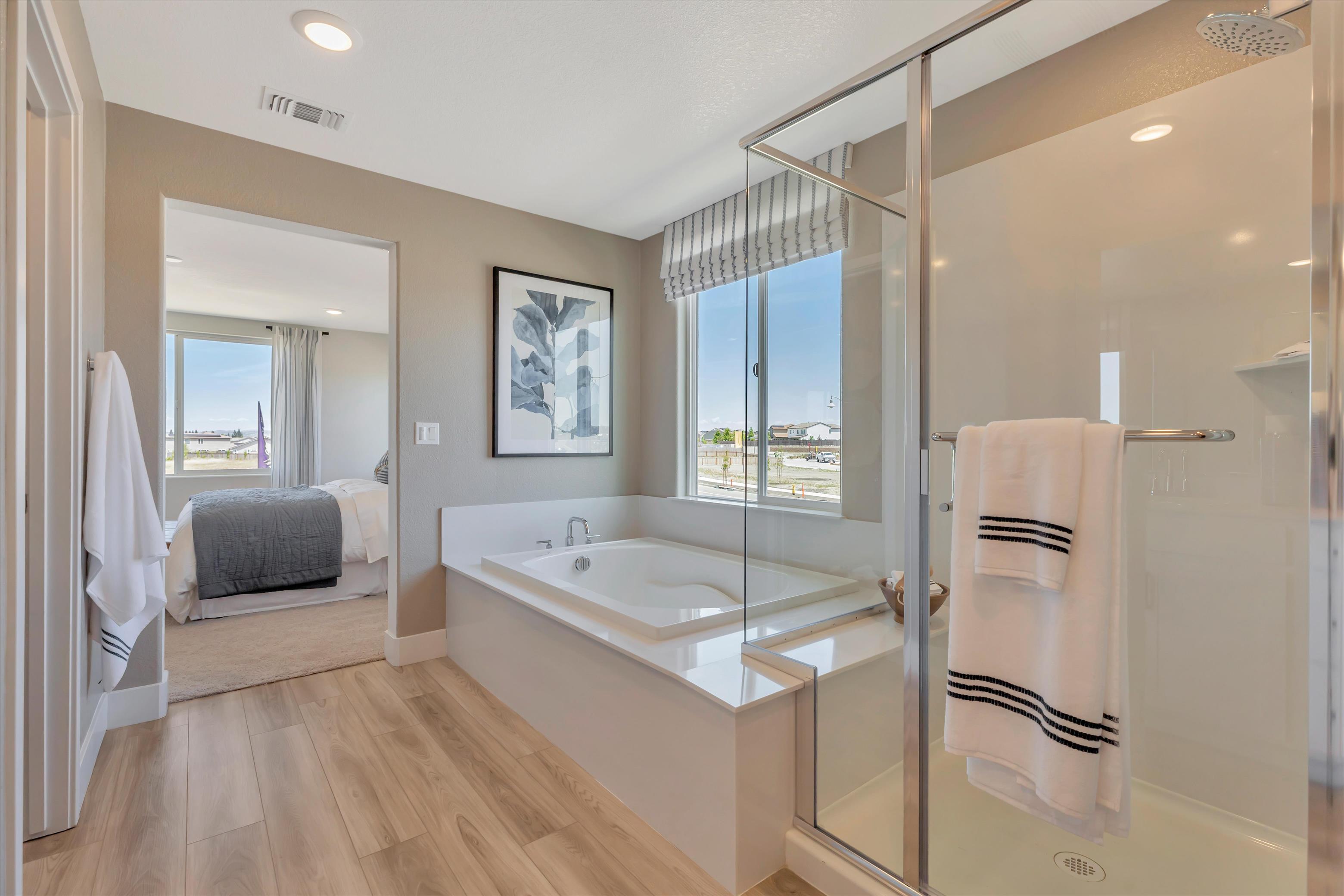 A bathroom with a tub and a shower.
