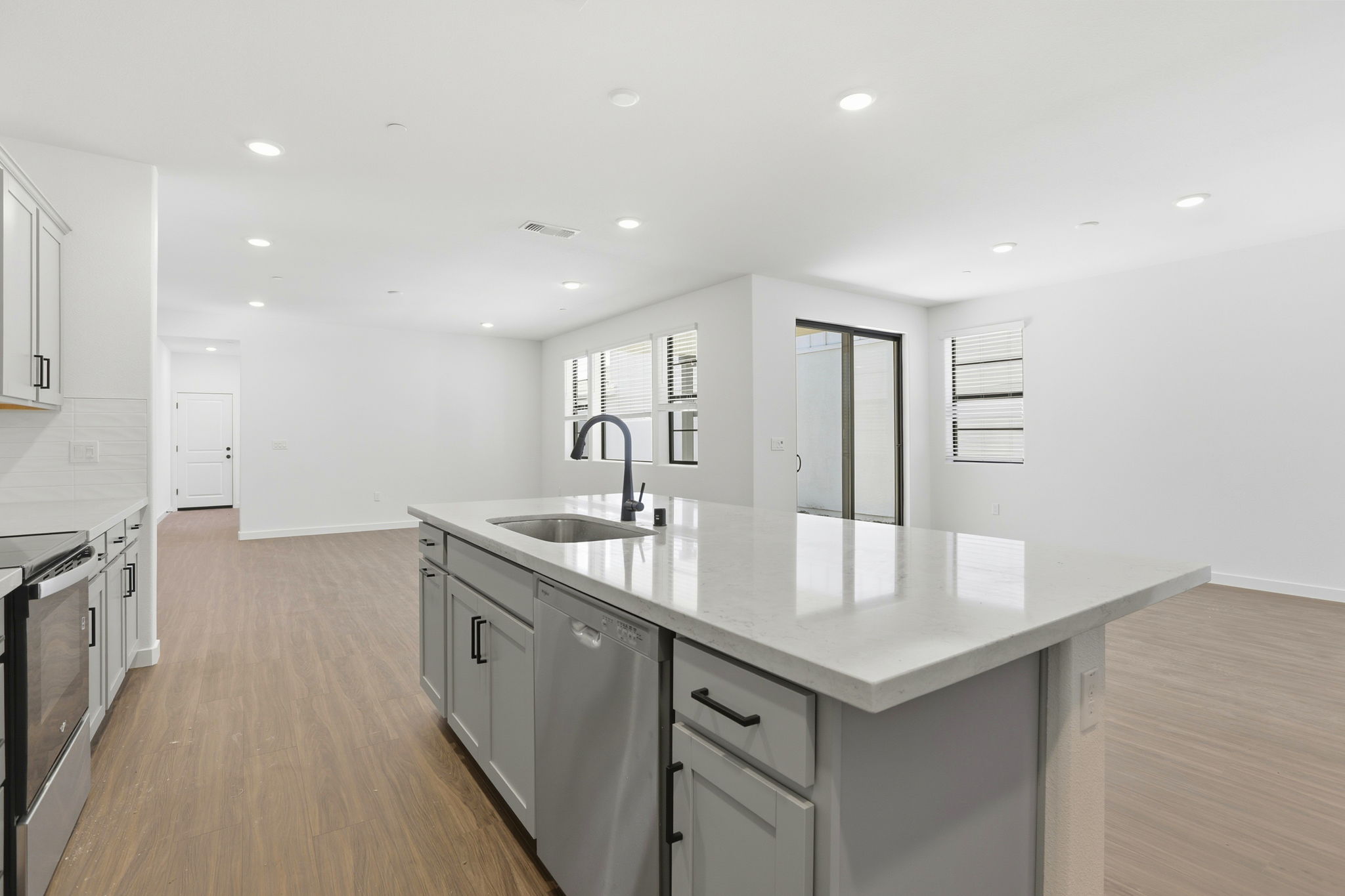 A kitchen with white cabinets.