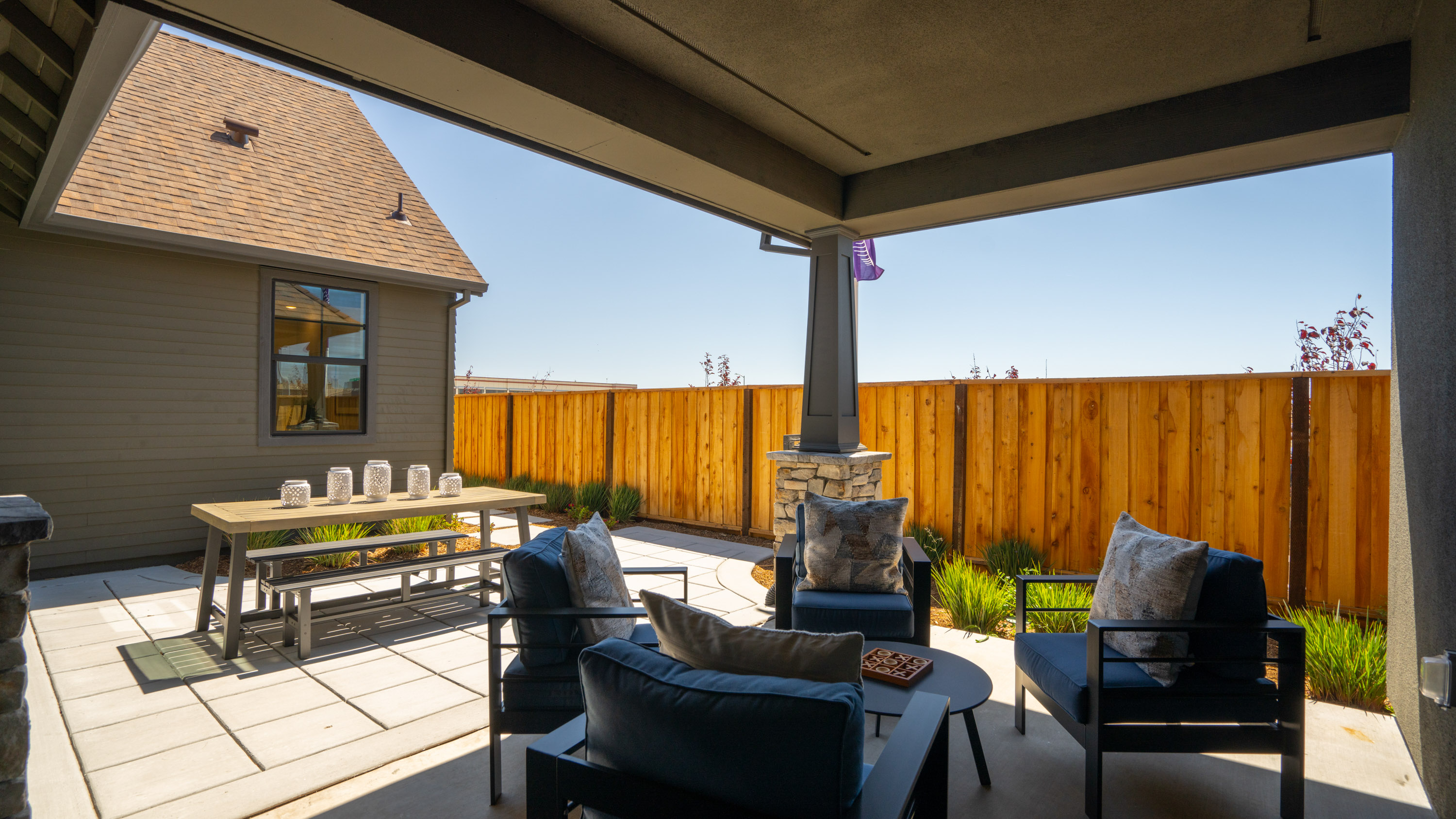 A patio with chairs and a table.