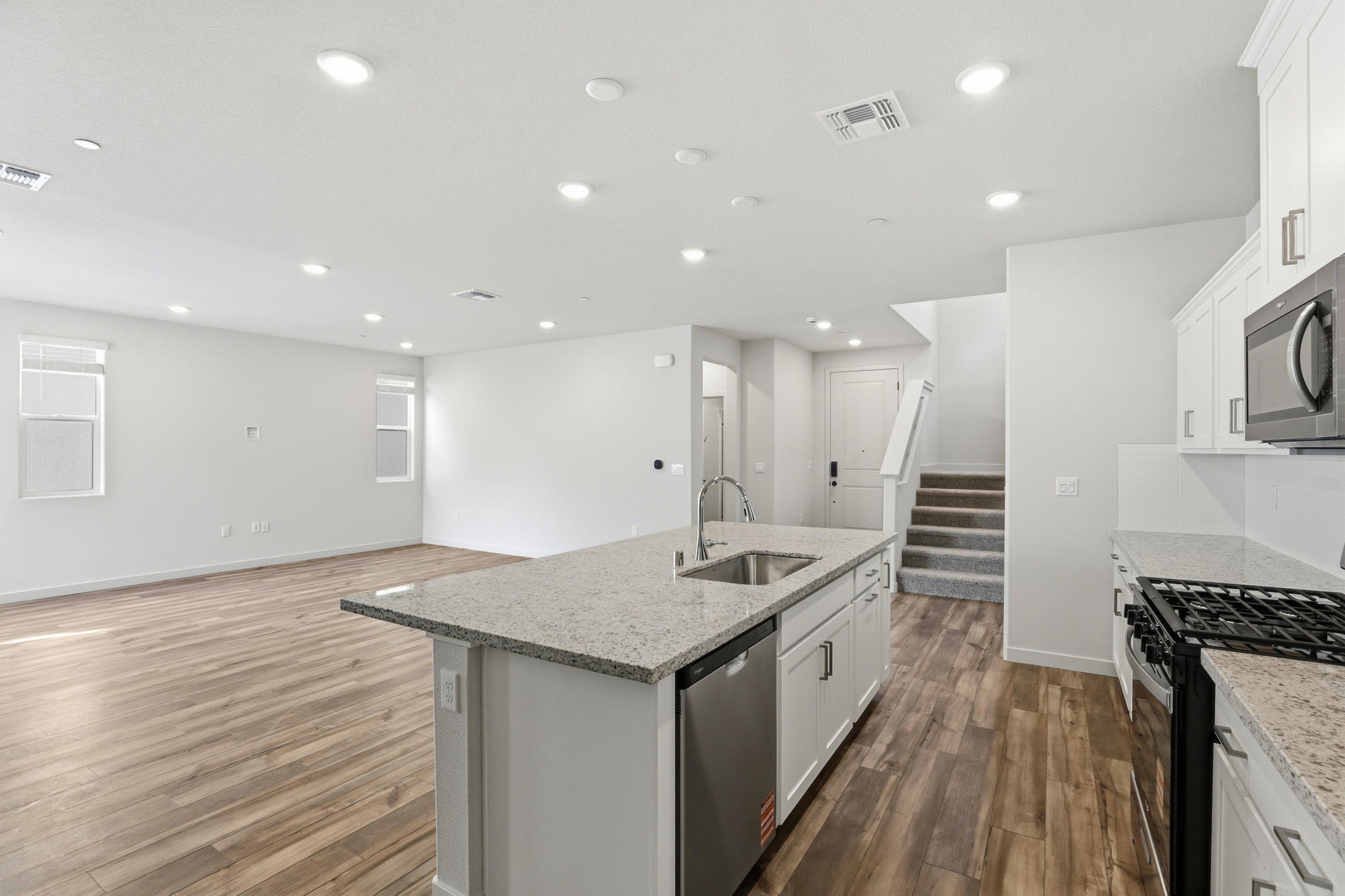 A kitchen with a wood floor.