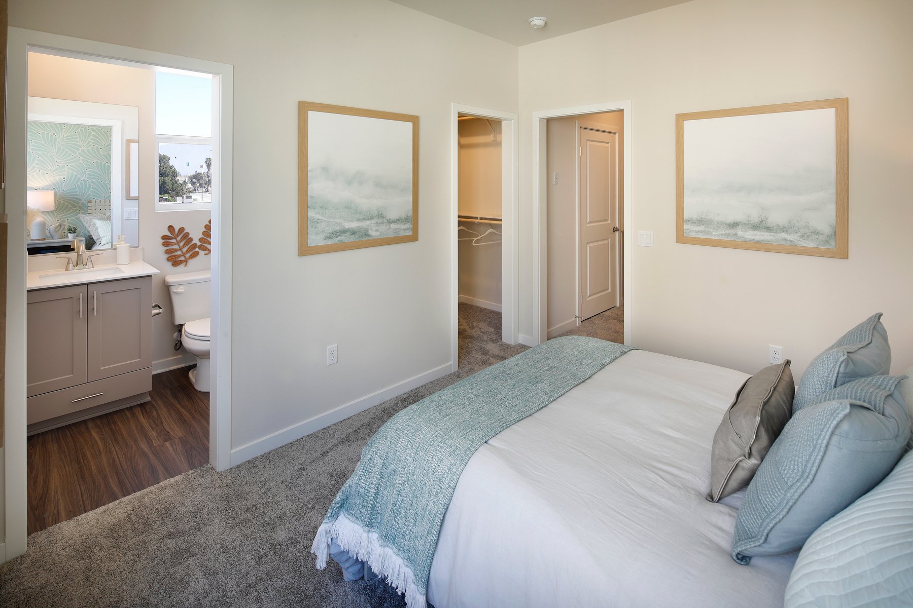 A bedroom with a bed and a mirror.