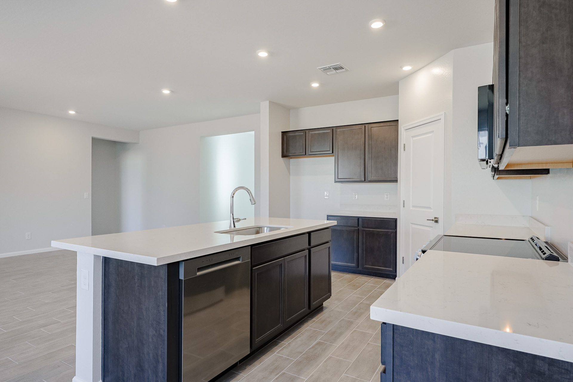 A kitchen with black cabinets.