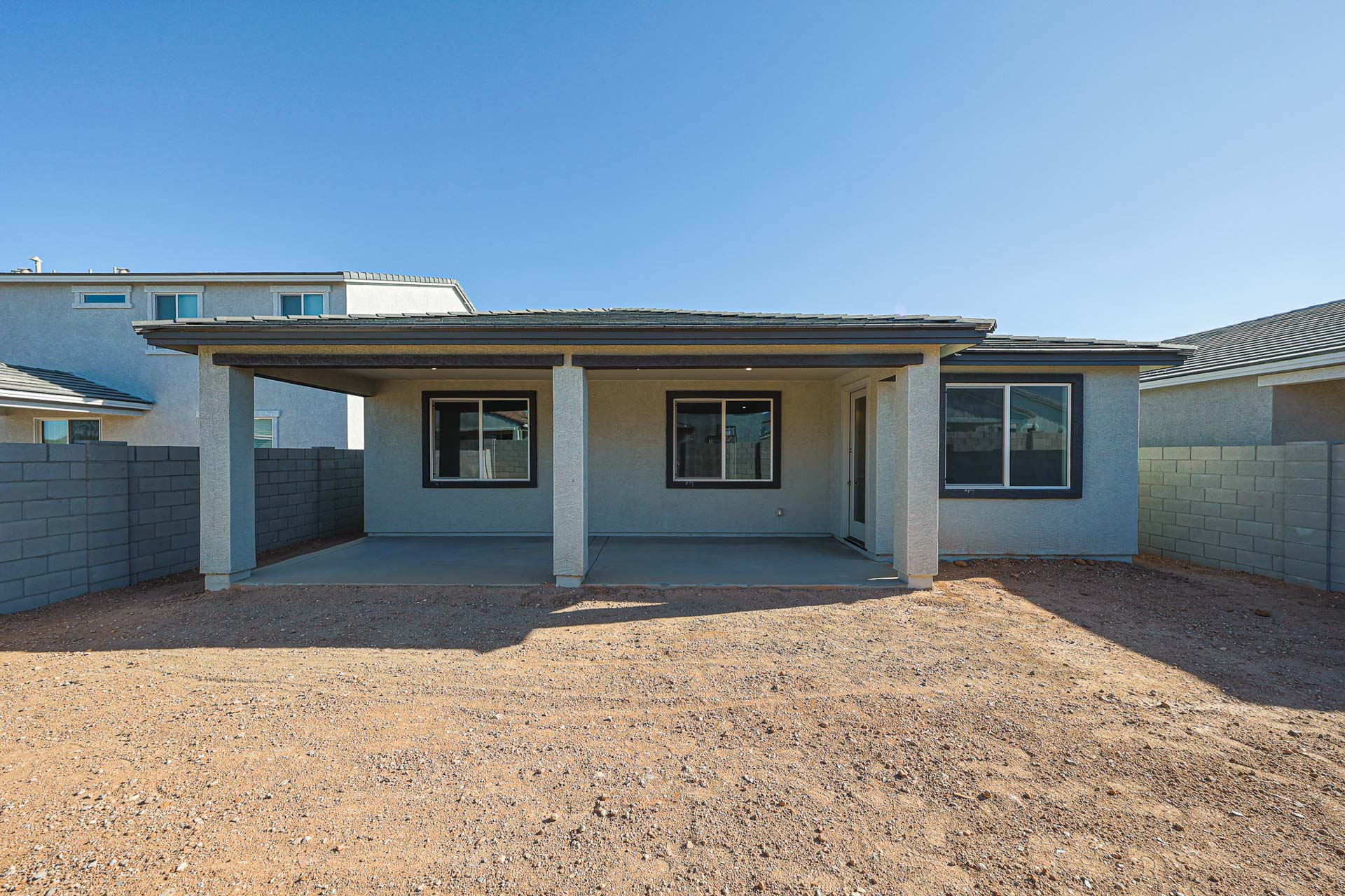 A building with a dirt yard.