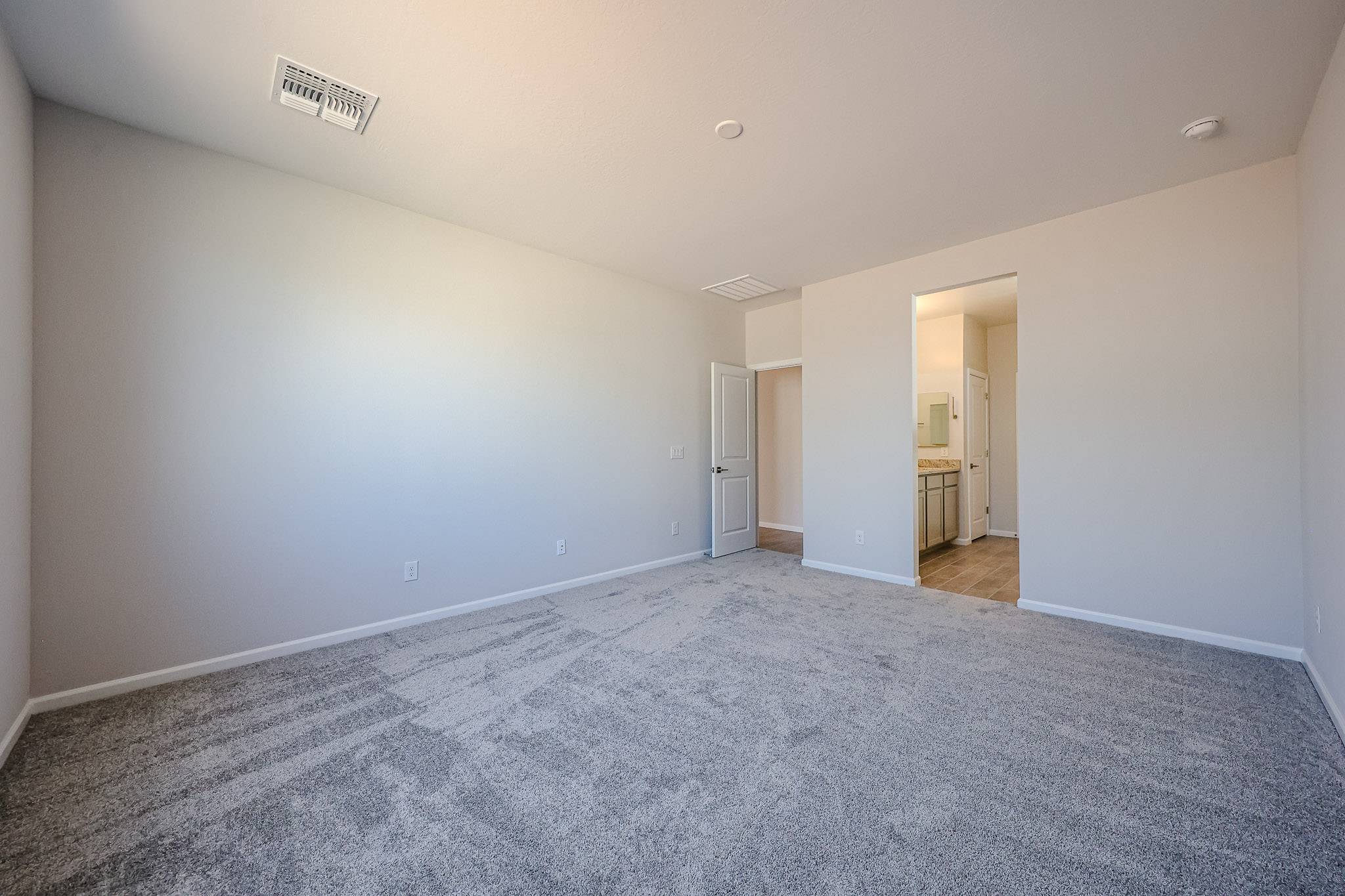 A long hallway with white walls.