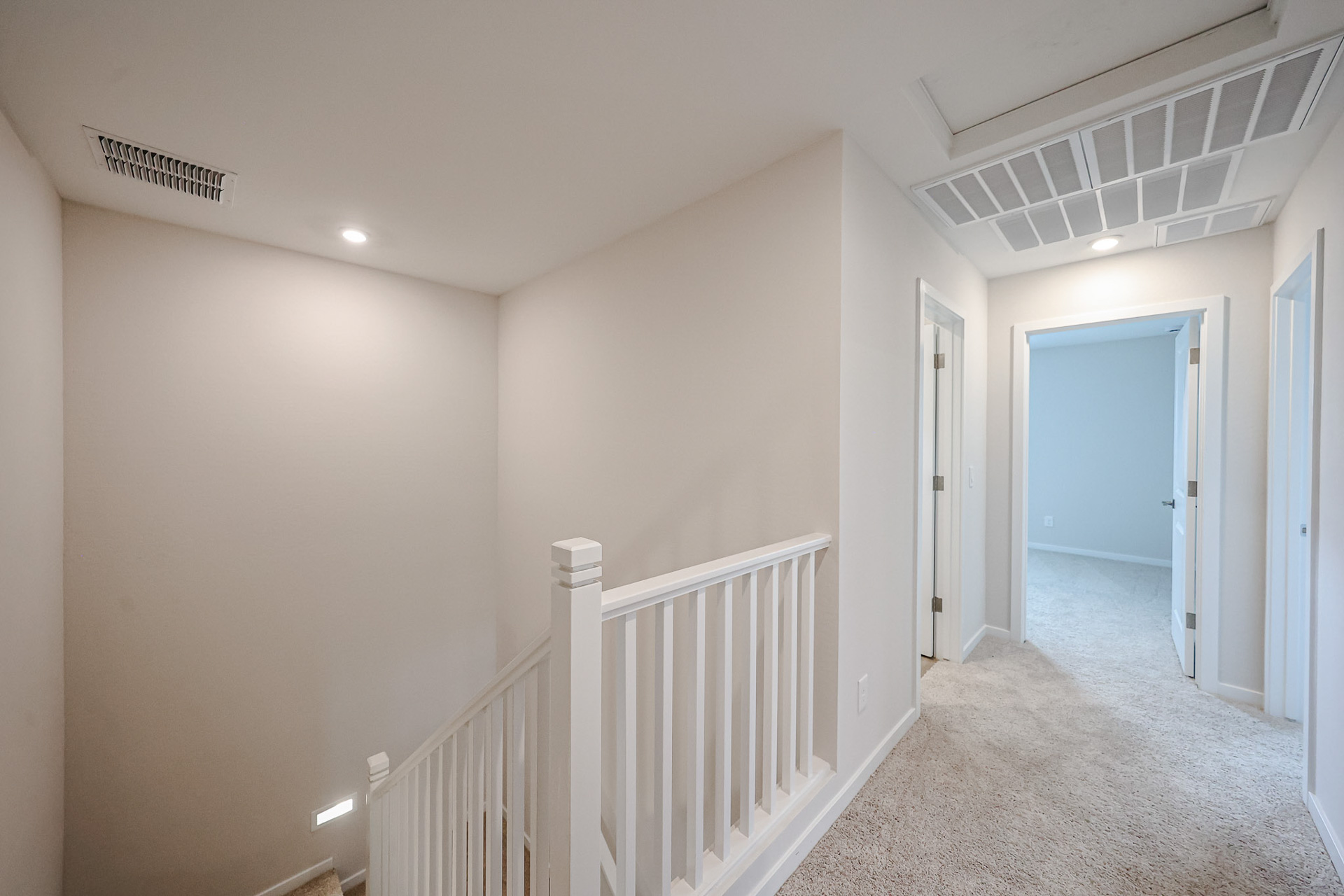 A hallway with white railings.