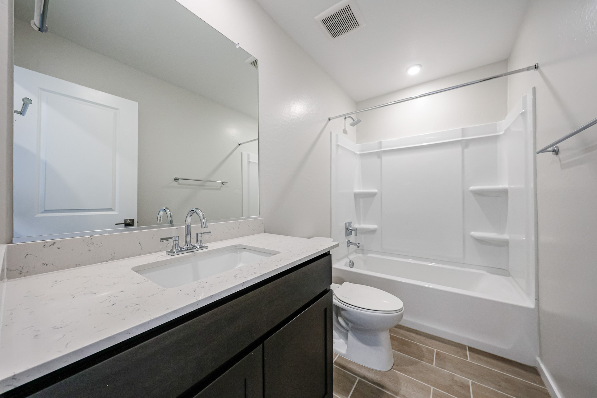 A bathroom with a tub sink and toilet.