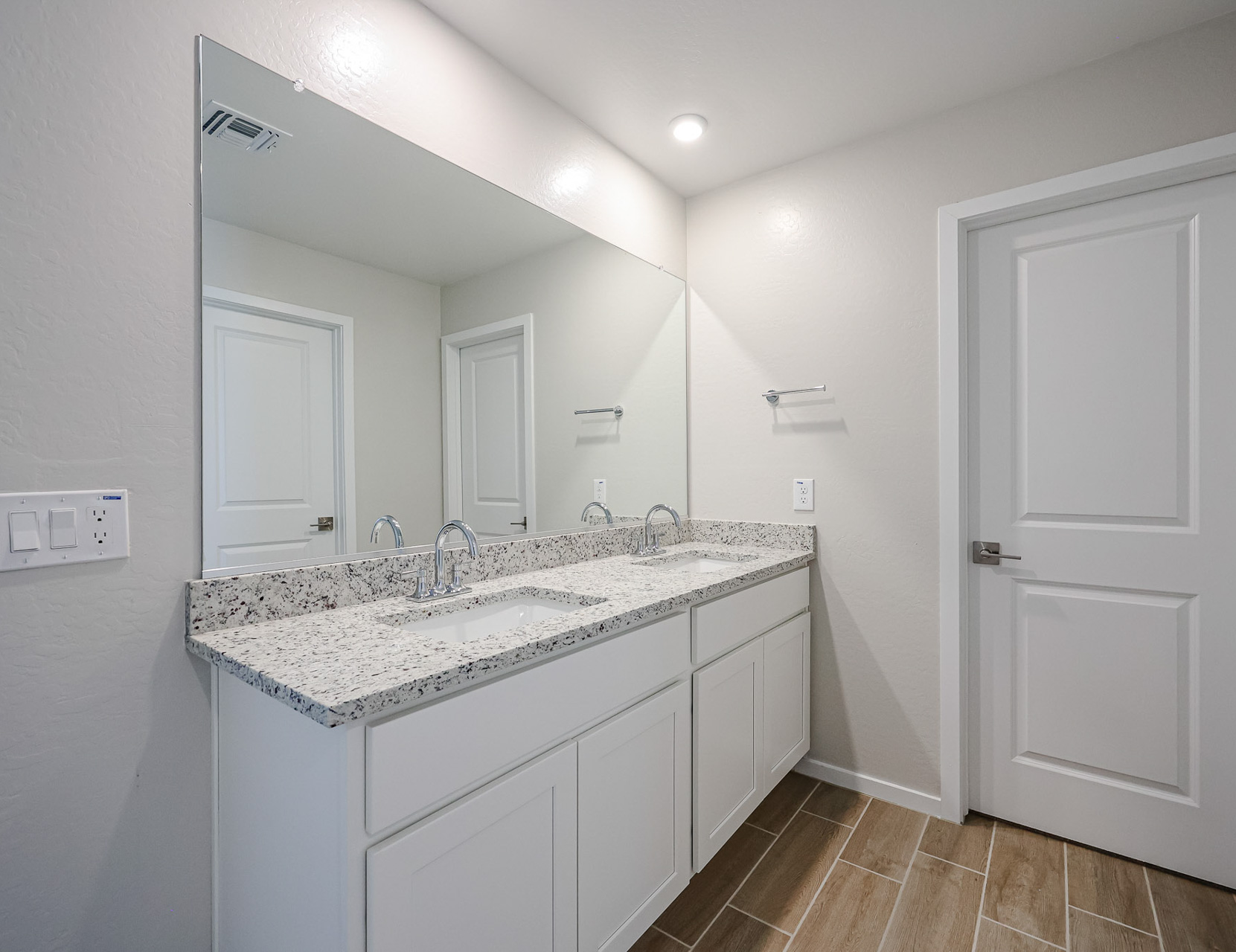 A bathroom with a marble countertop.