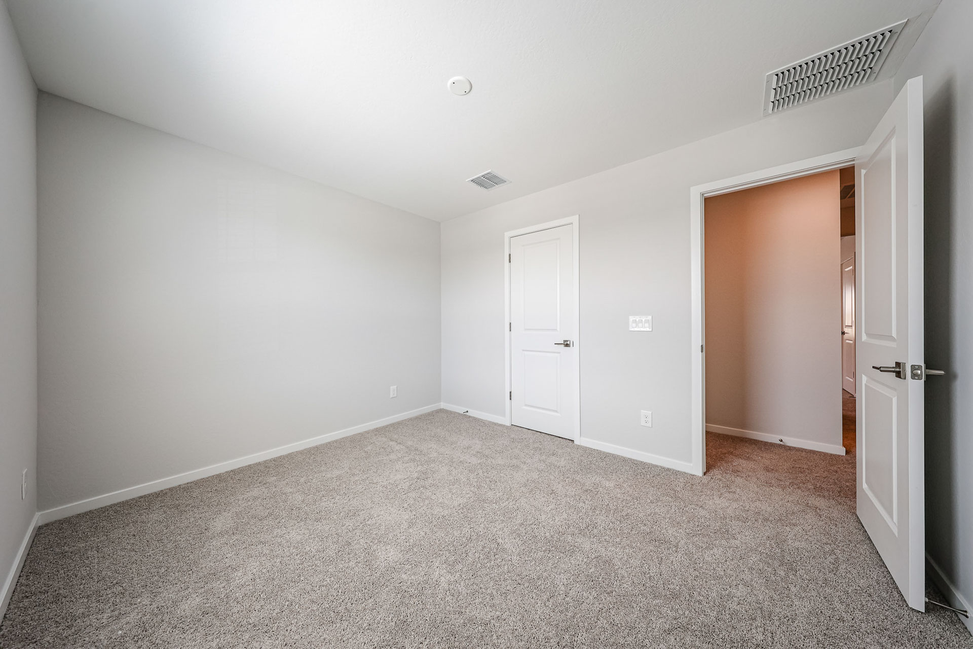A hallway with white doors.