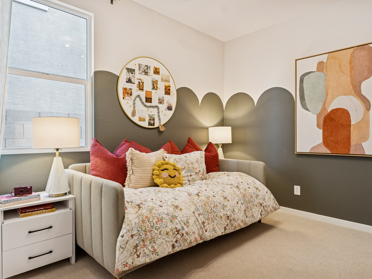 A white couch with red pillows.