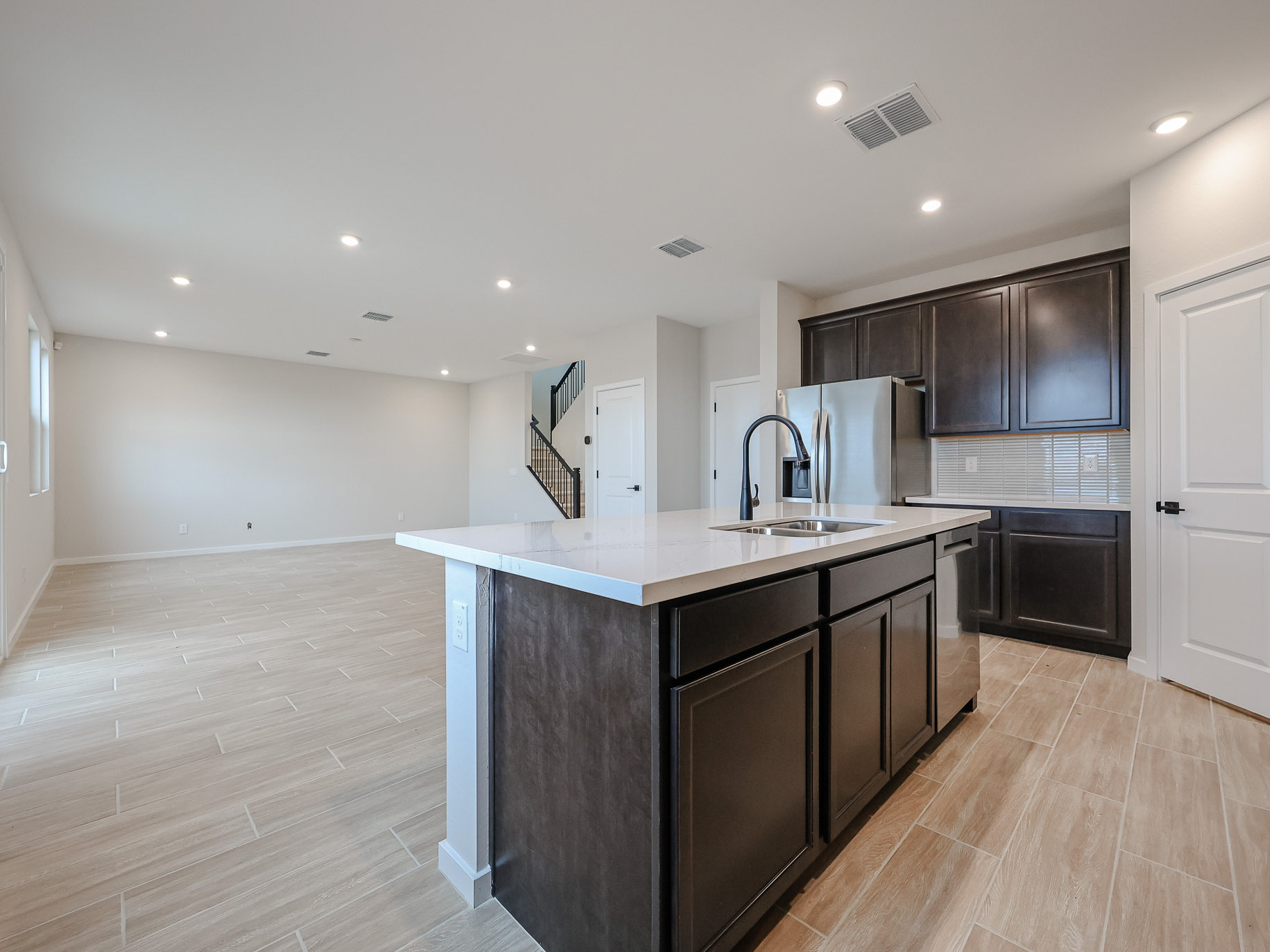 A kitchen with black cabinets.