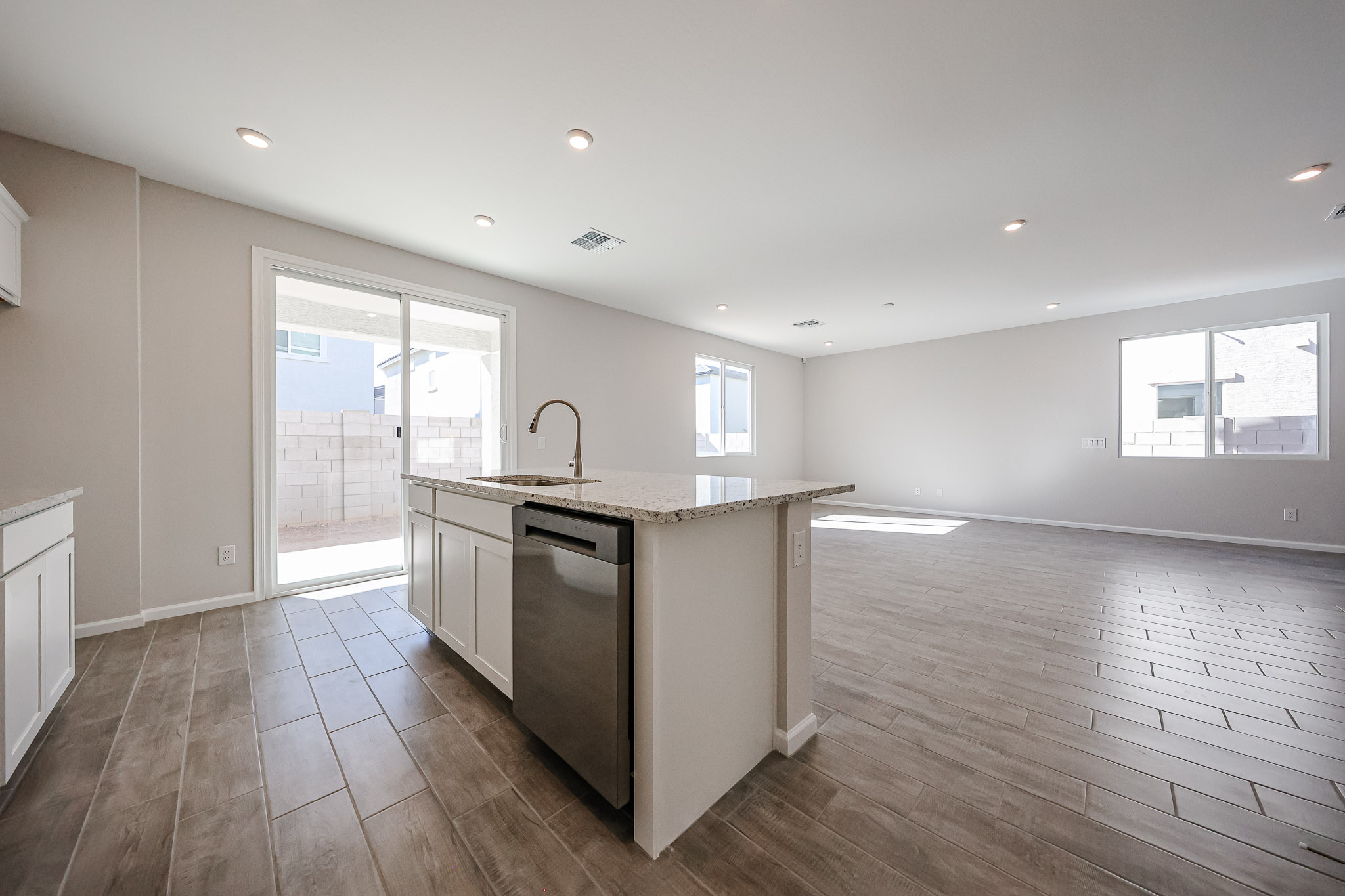 A kitchen with a wood floor.
