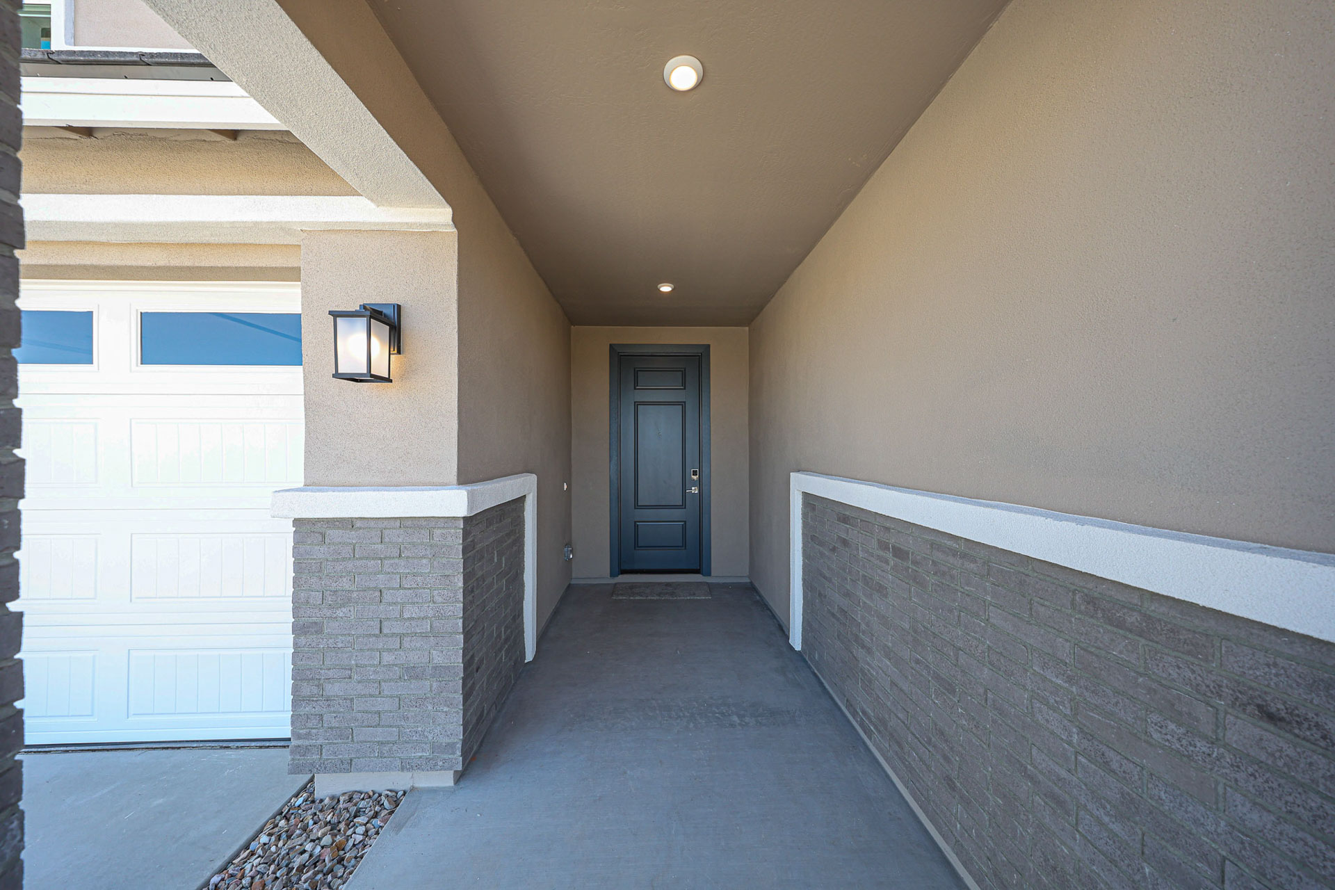A hallway with a door and a stone wall.