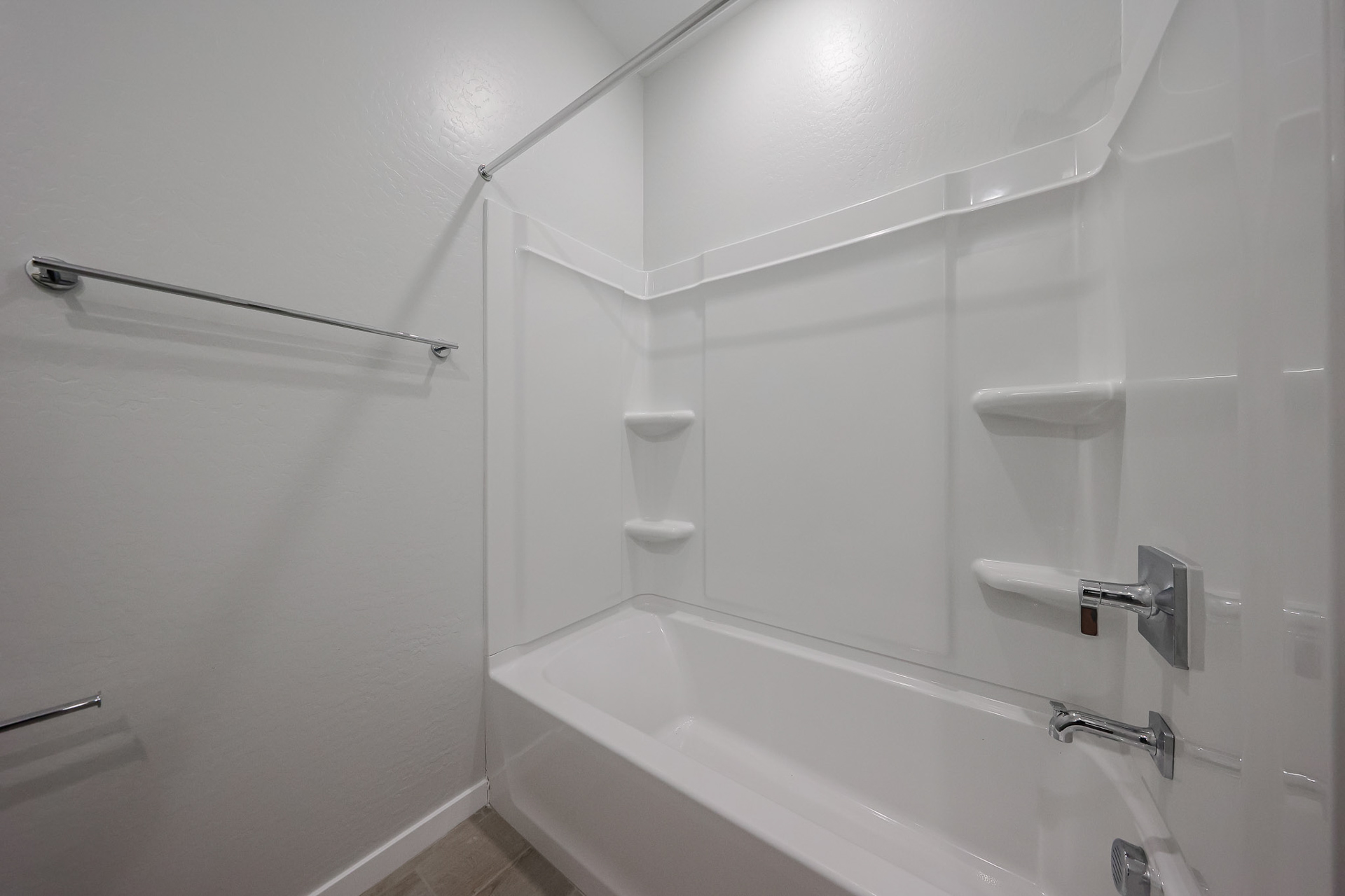 A bathroom with a bathtub and toilet.