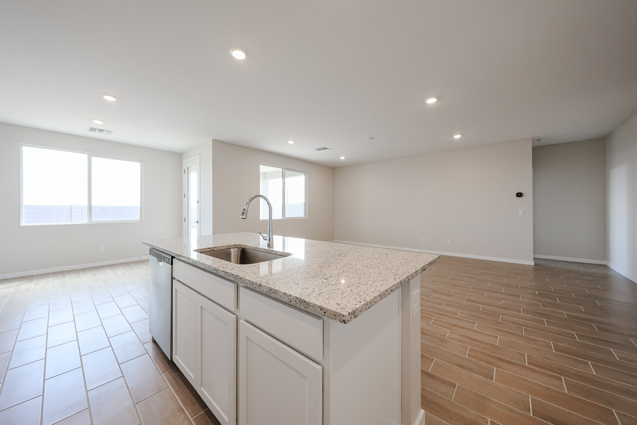 A kitchen with a marble countertop.