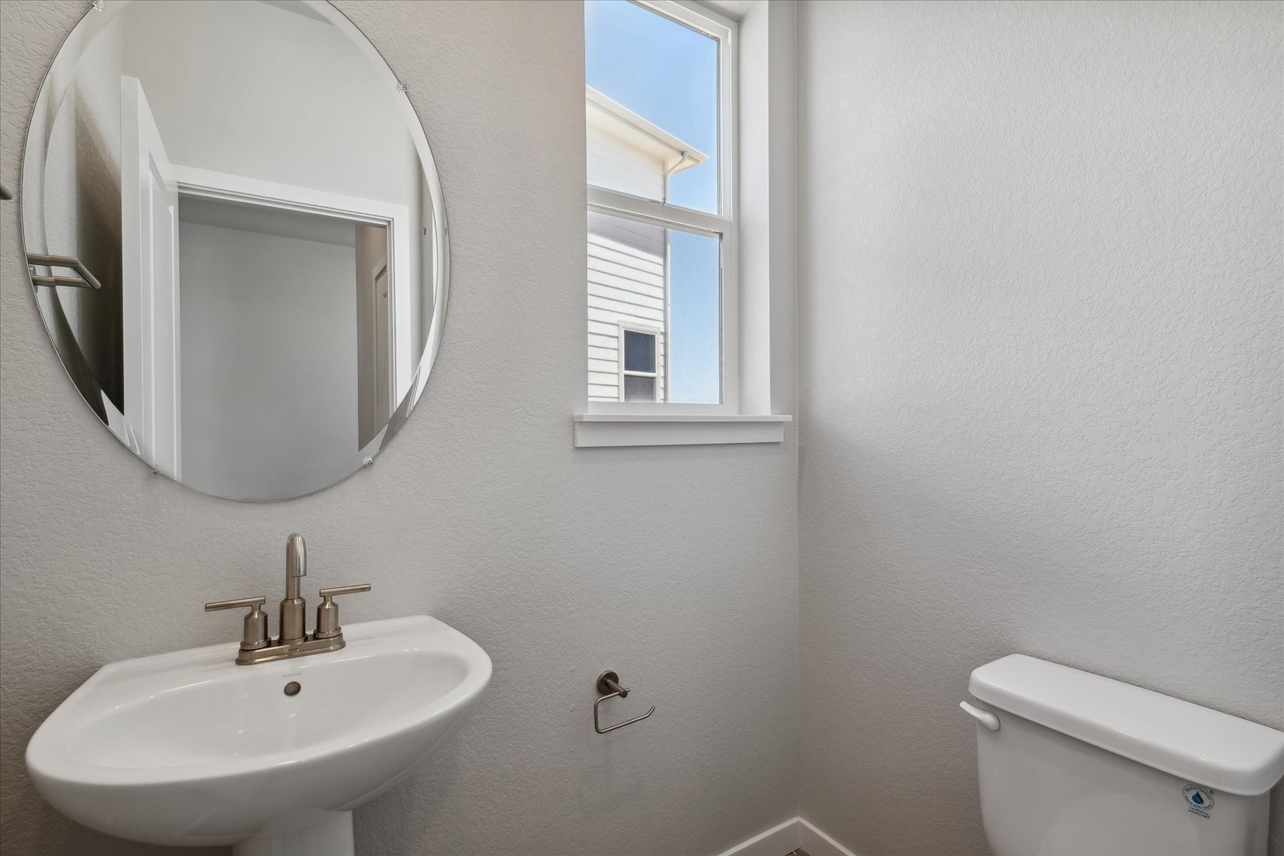 A bathroom with a mirror and sink.