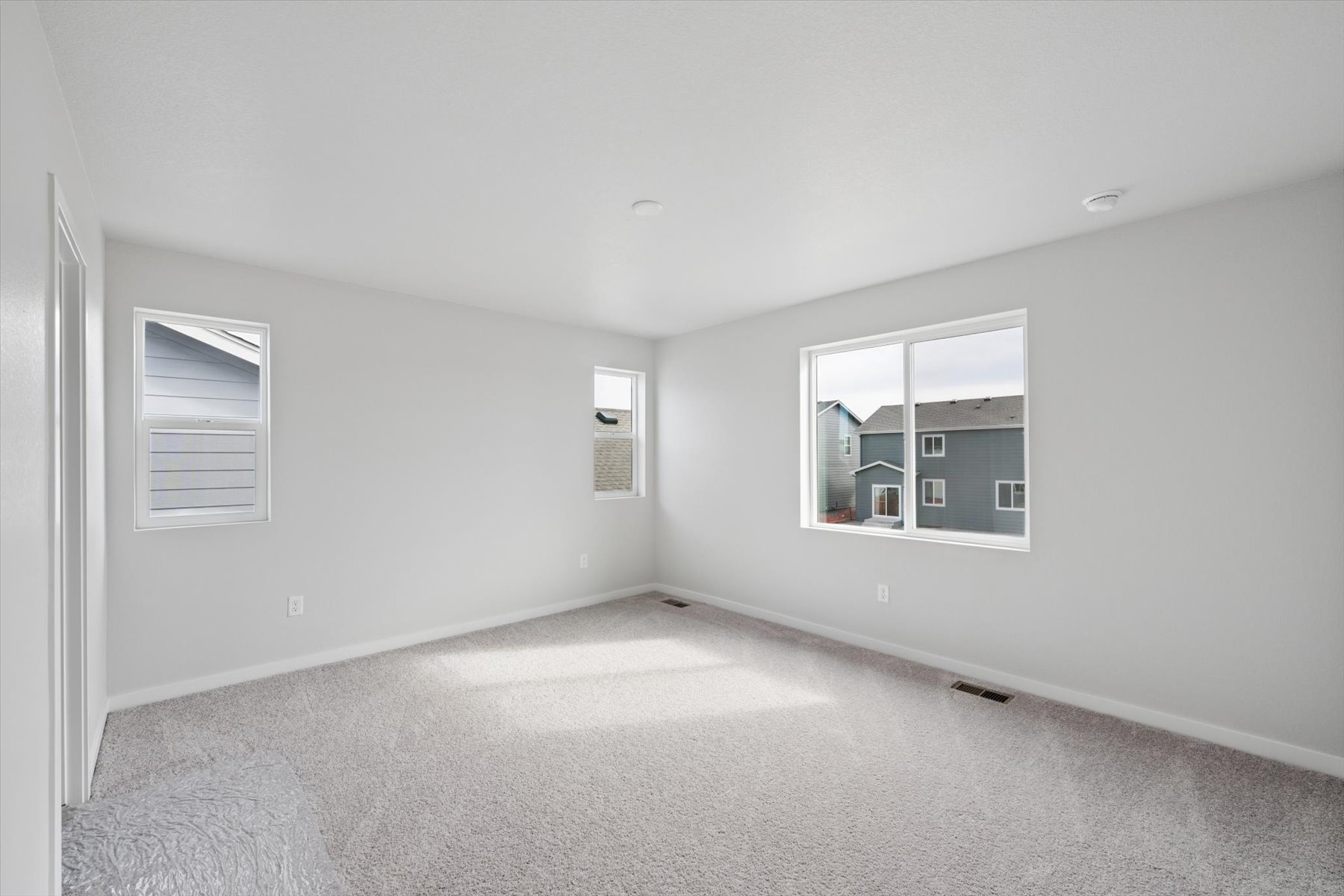 A room with a window and a carpet.