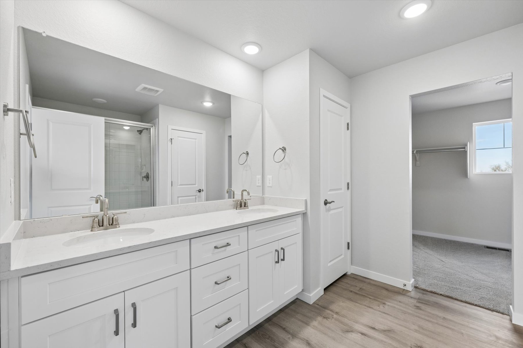 A bathroom with white cabinets.