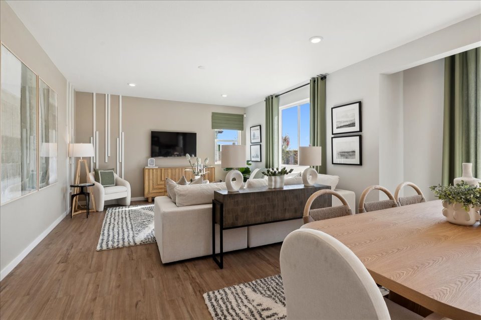 A large living room with a large table and chairs.
