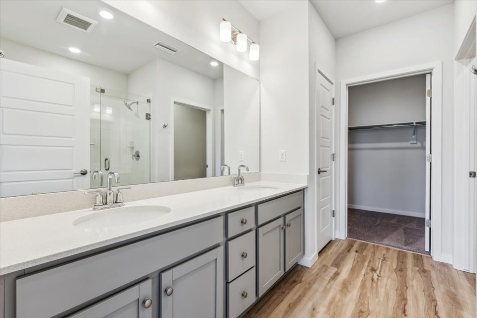 A bathroom with a large mirror.