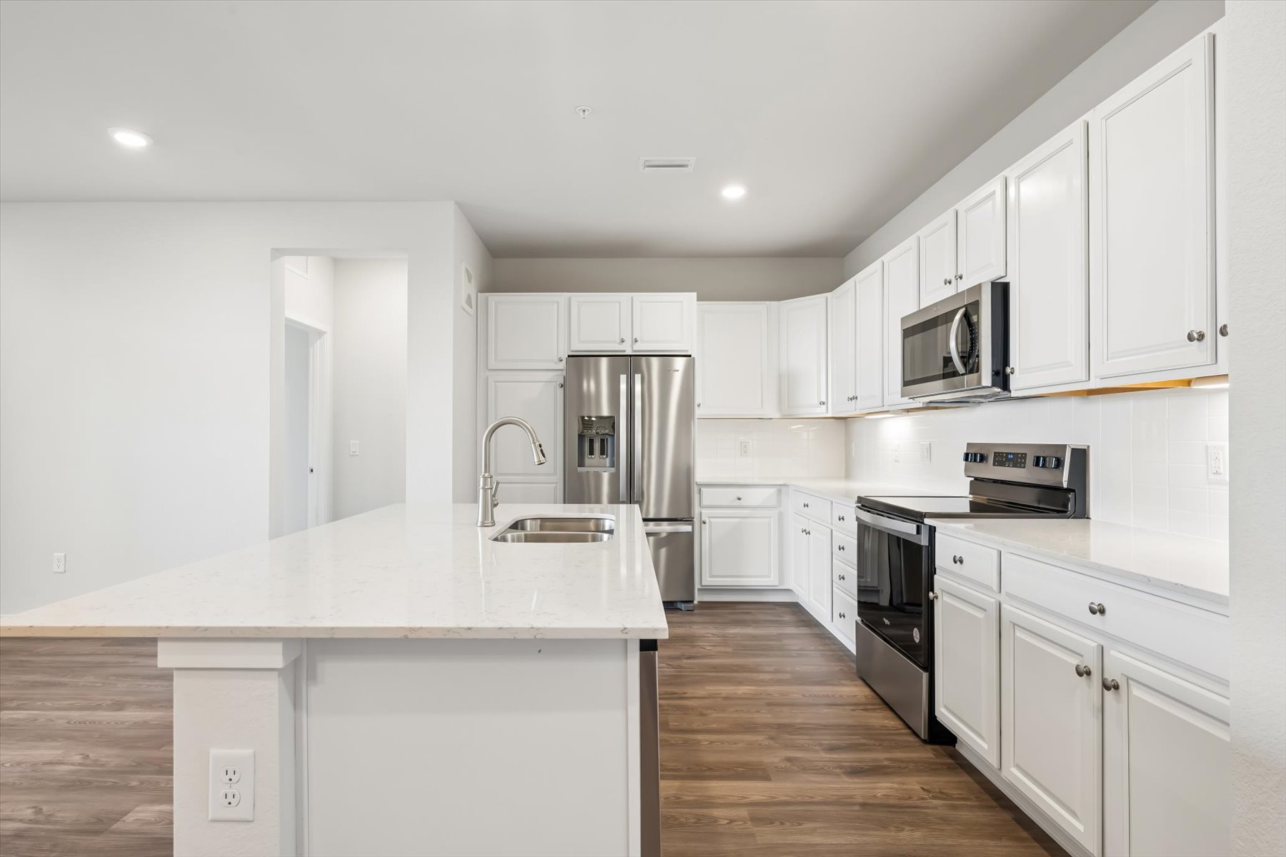A kitchen with white cabinets.
