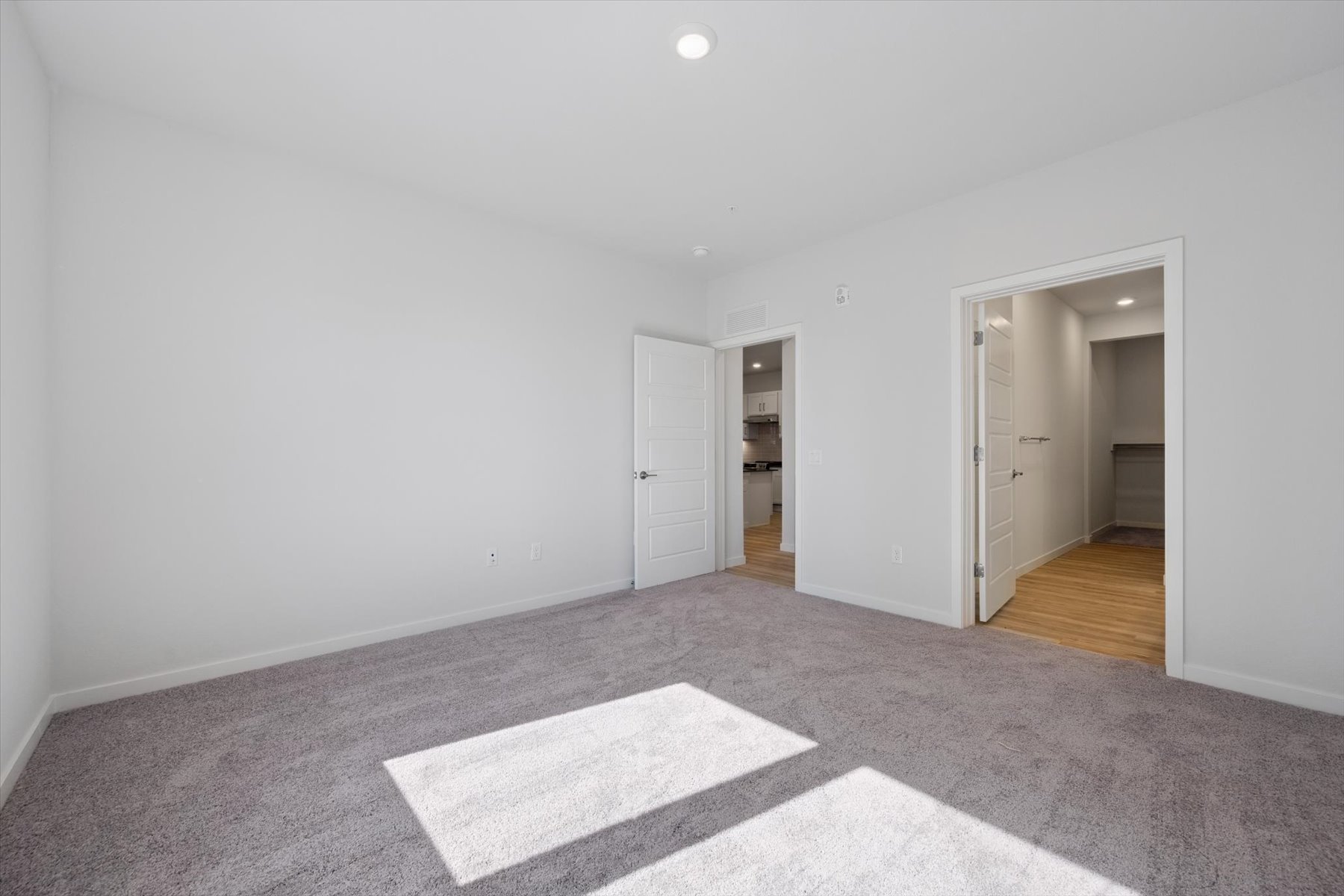 A hallway with white doors.