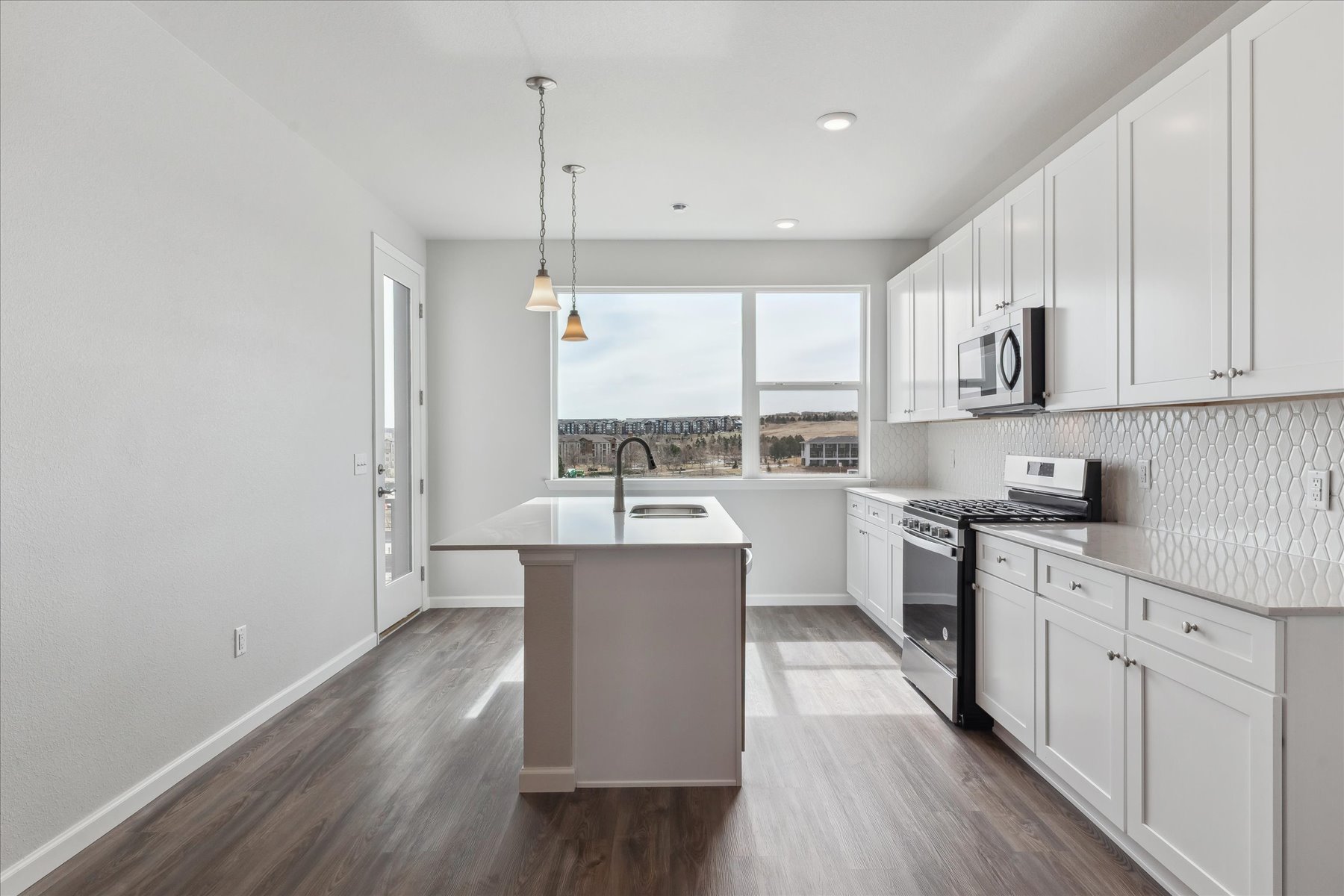 A kitchen with white cabinets.