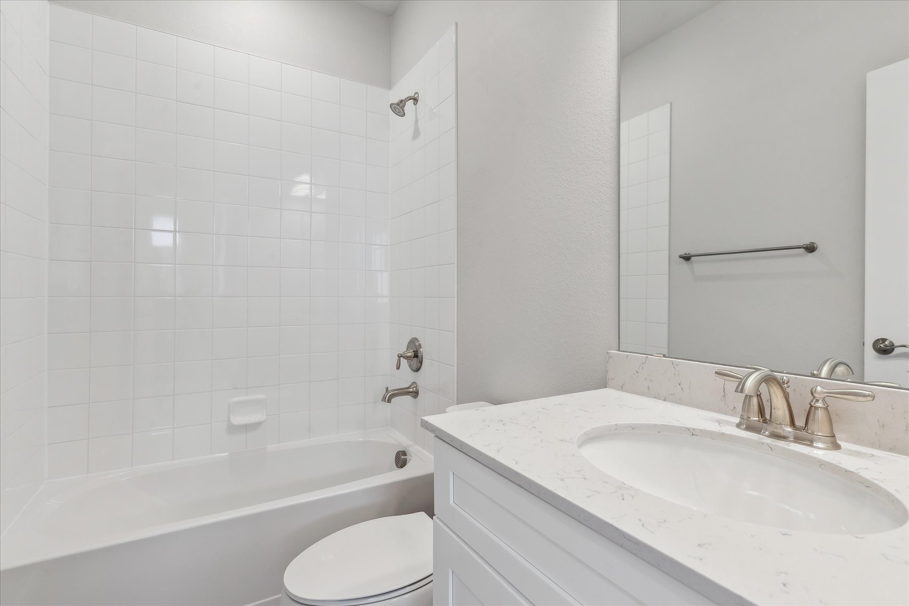 A bathroom with a tub sink and toilet.