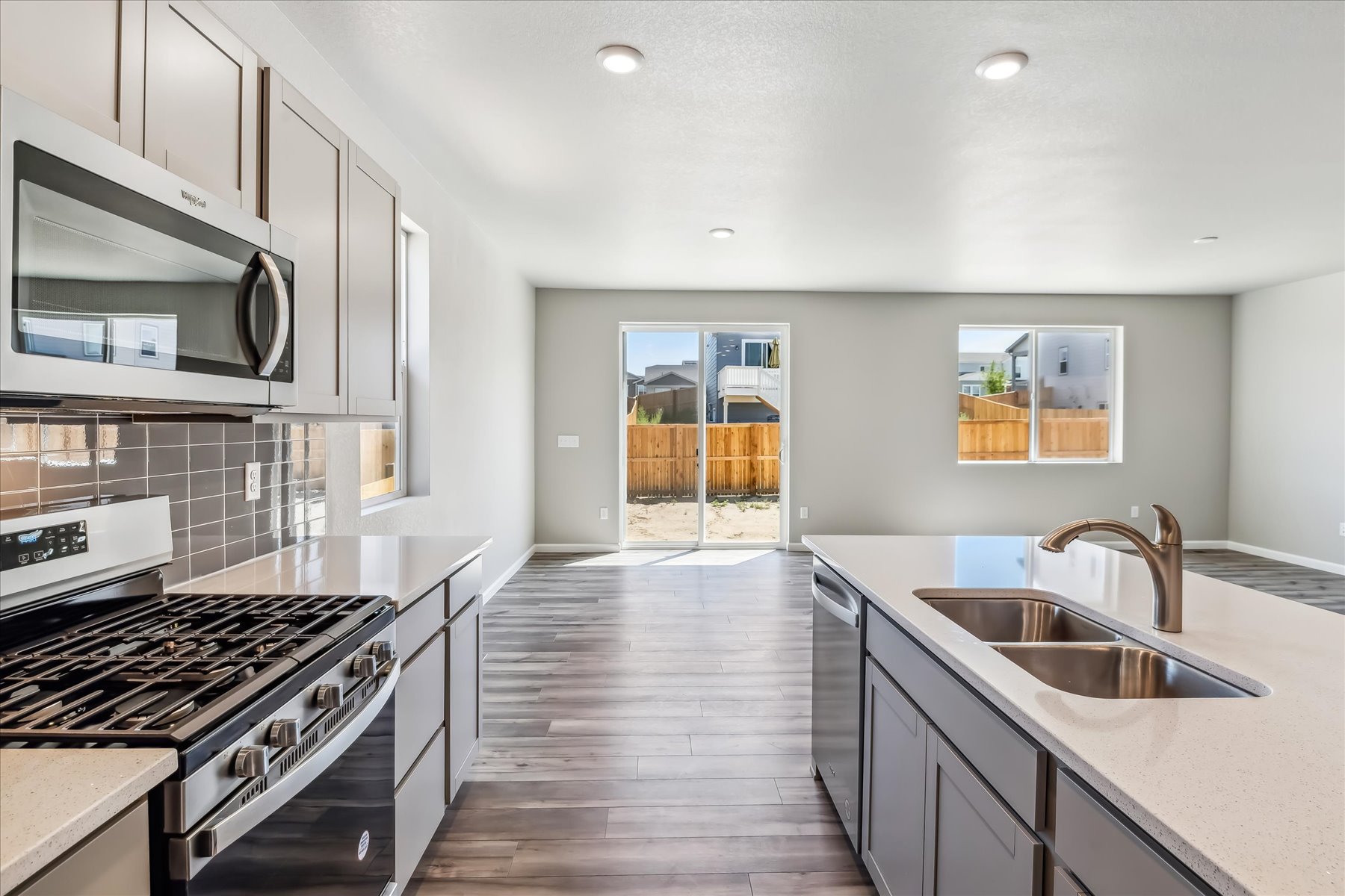 A kitchen with white cabinets.