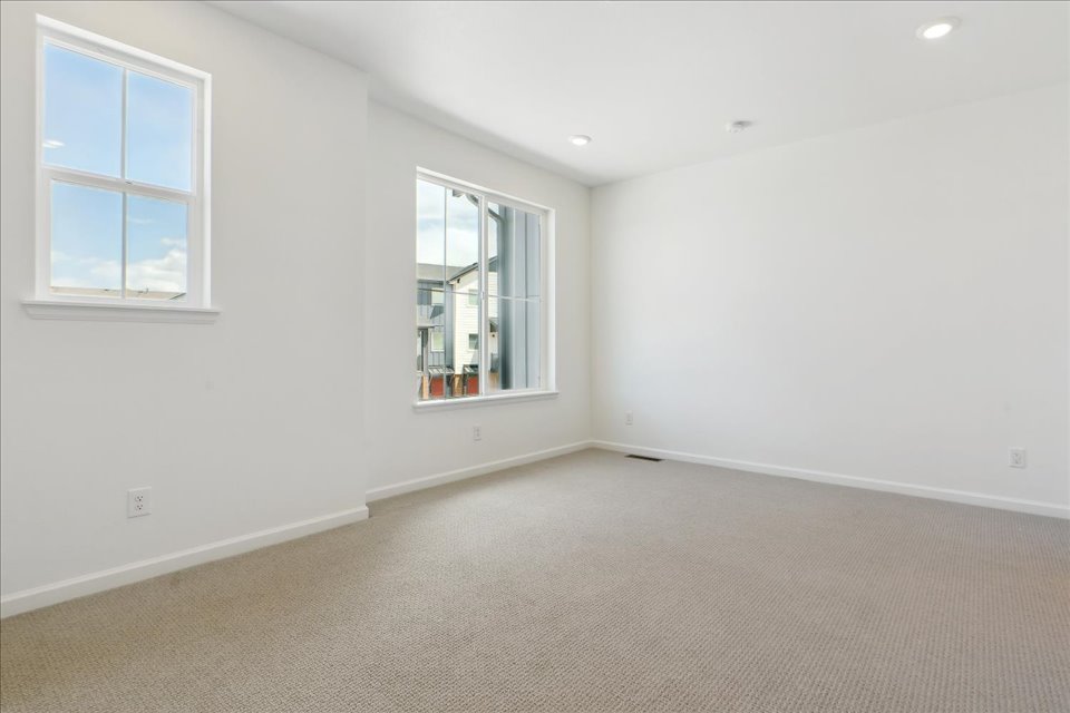 A room with a window and a carpet.