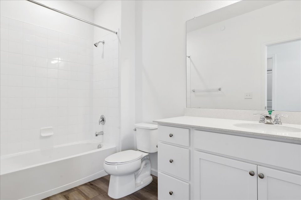 A bathroom with a tub toilet and sink.