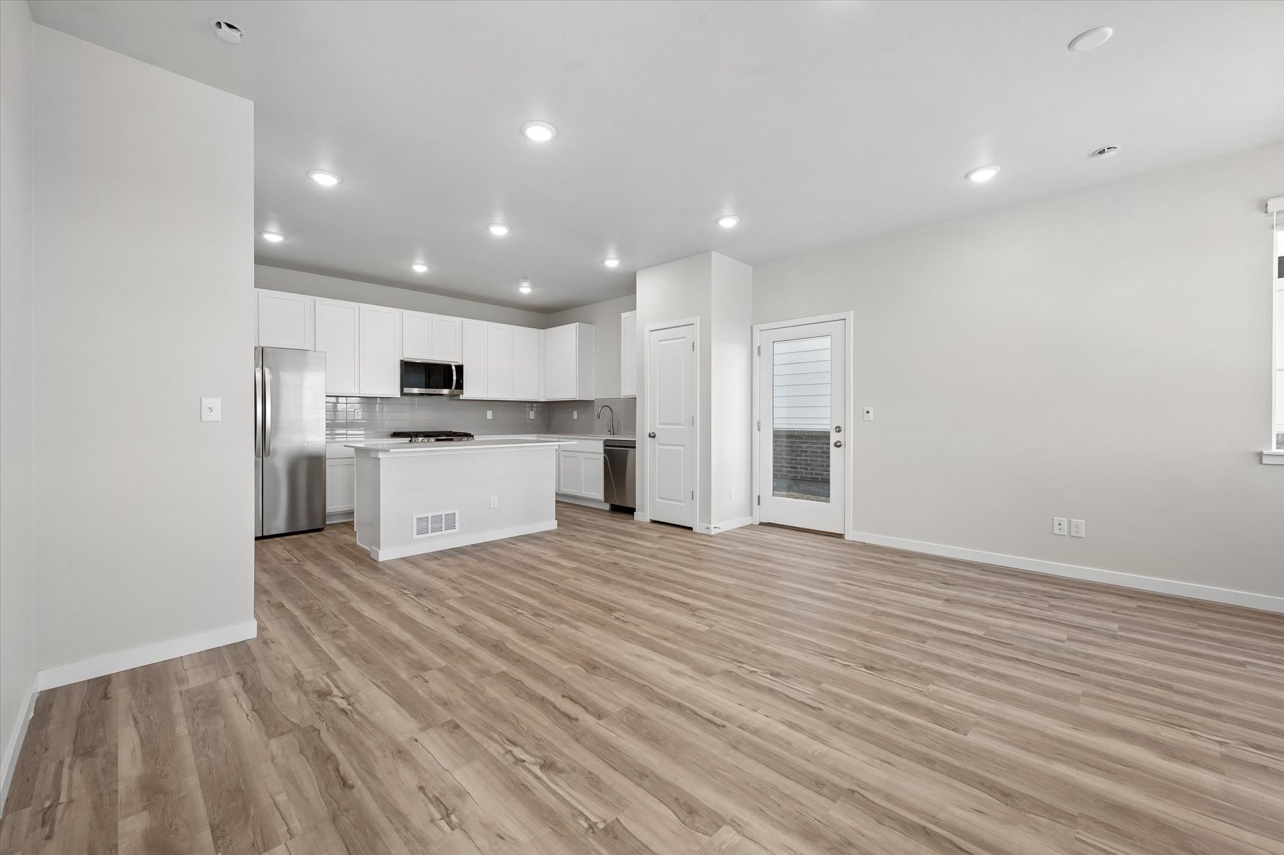 A large kitchen with white cabinets.