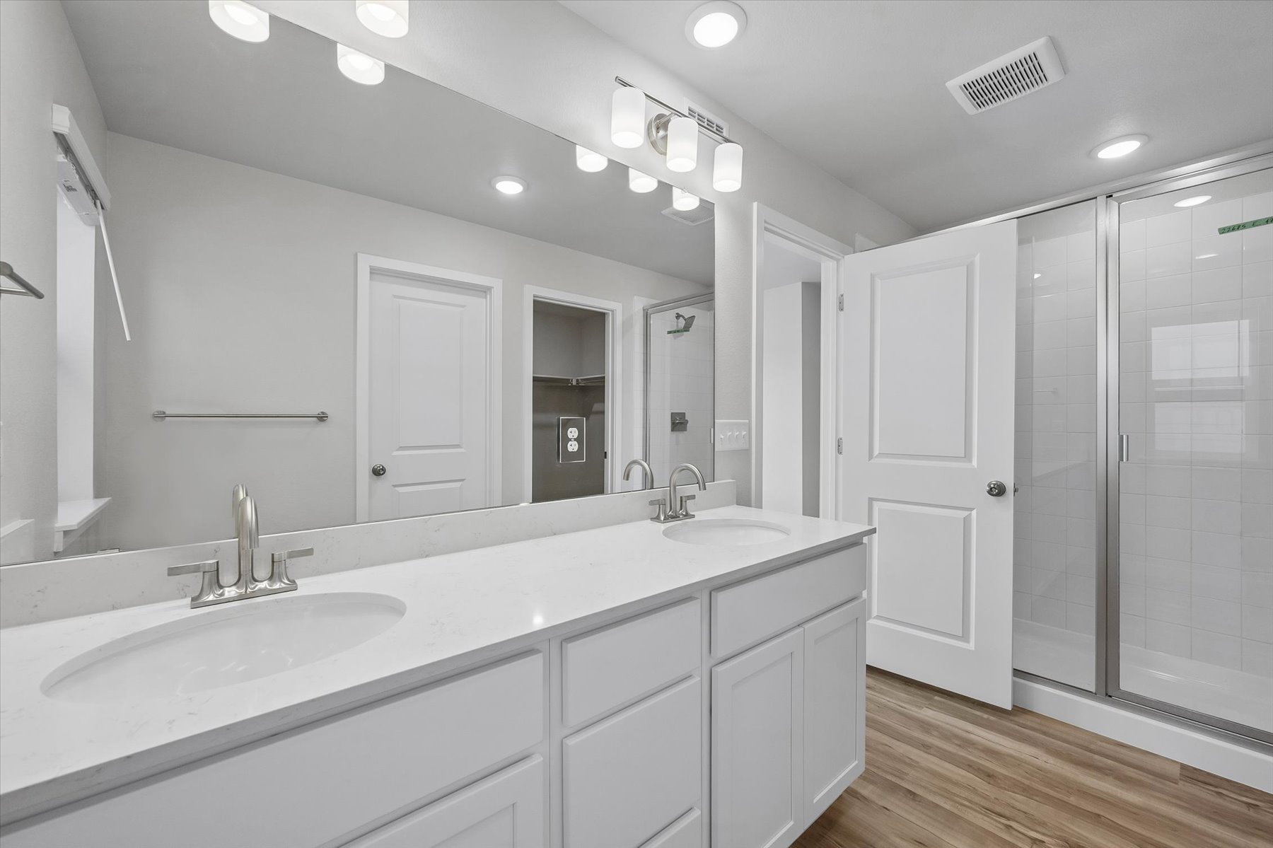 A bathroom with a large mirror.