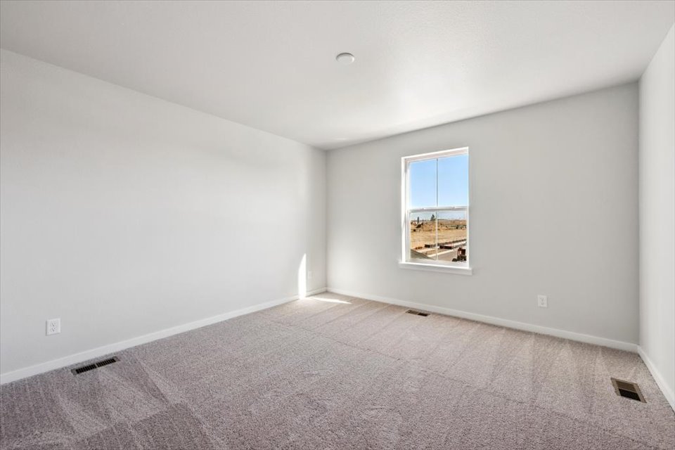 A room with a window and carpet.