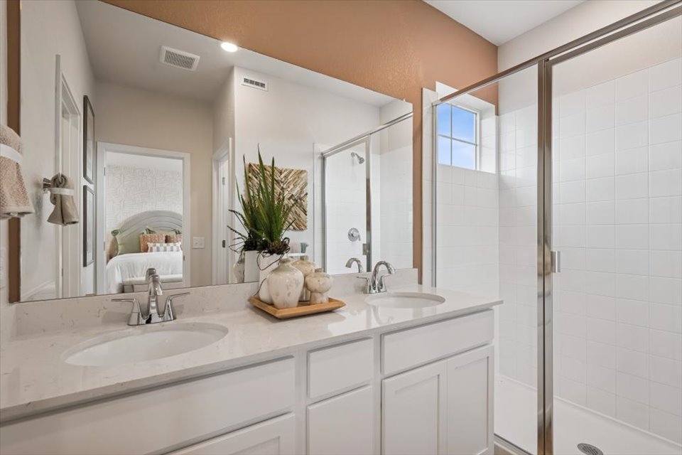 A bathroom with a large mirror.
