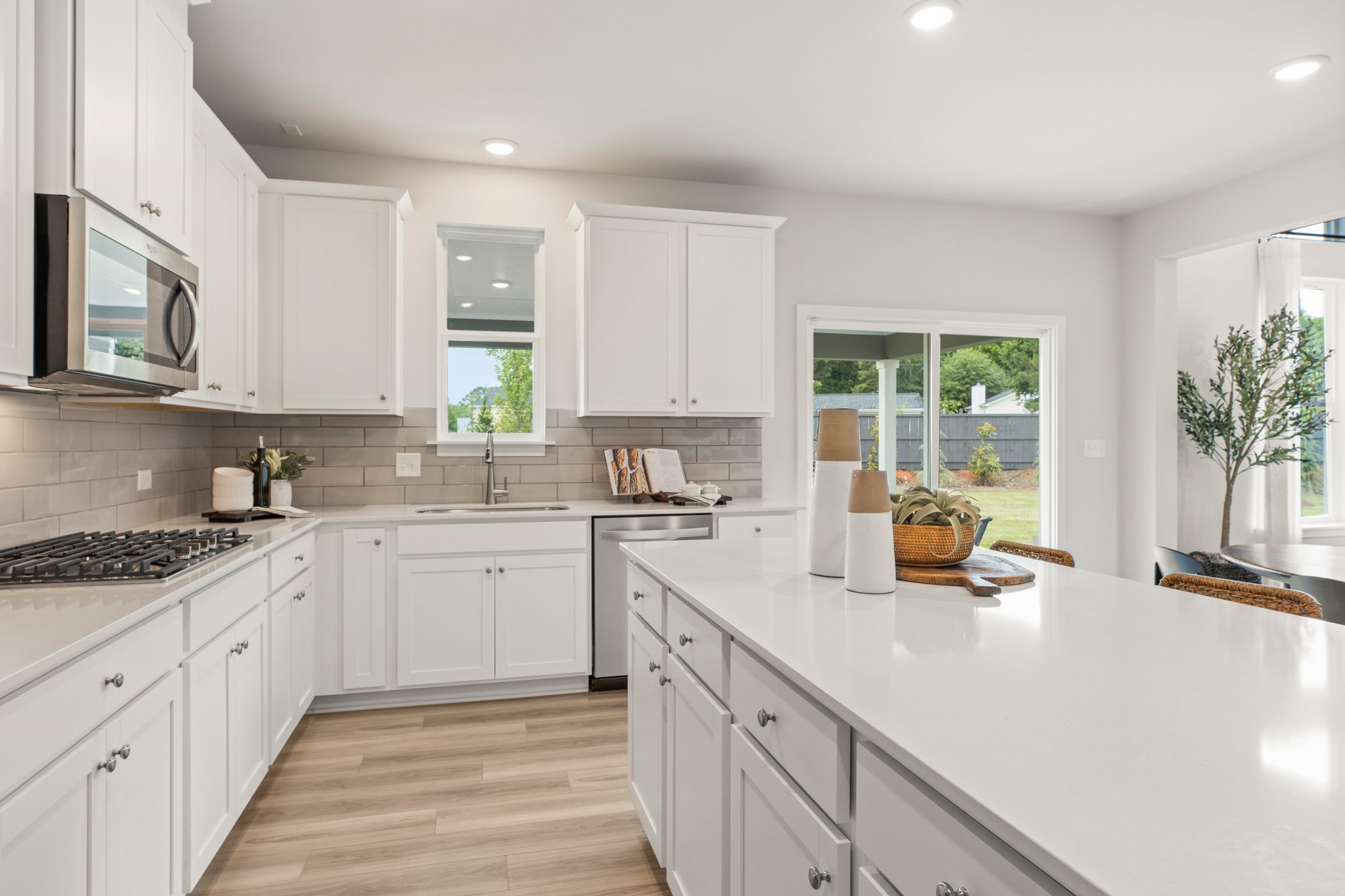 A kitchen with white cabinets.