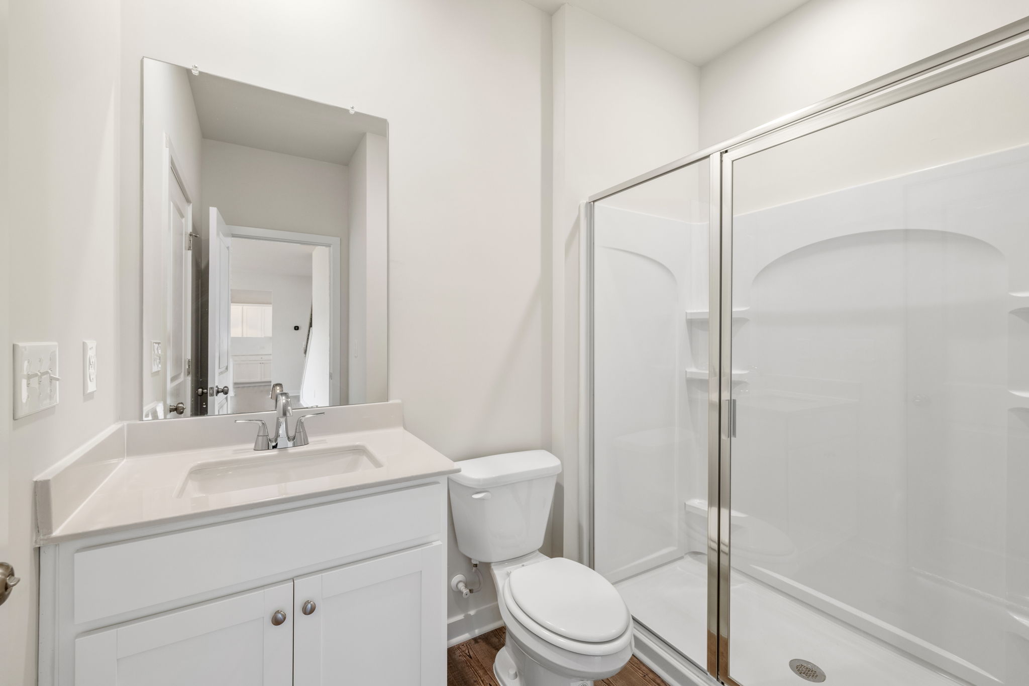 A bathroom with a glass shower.