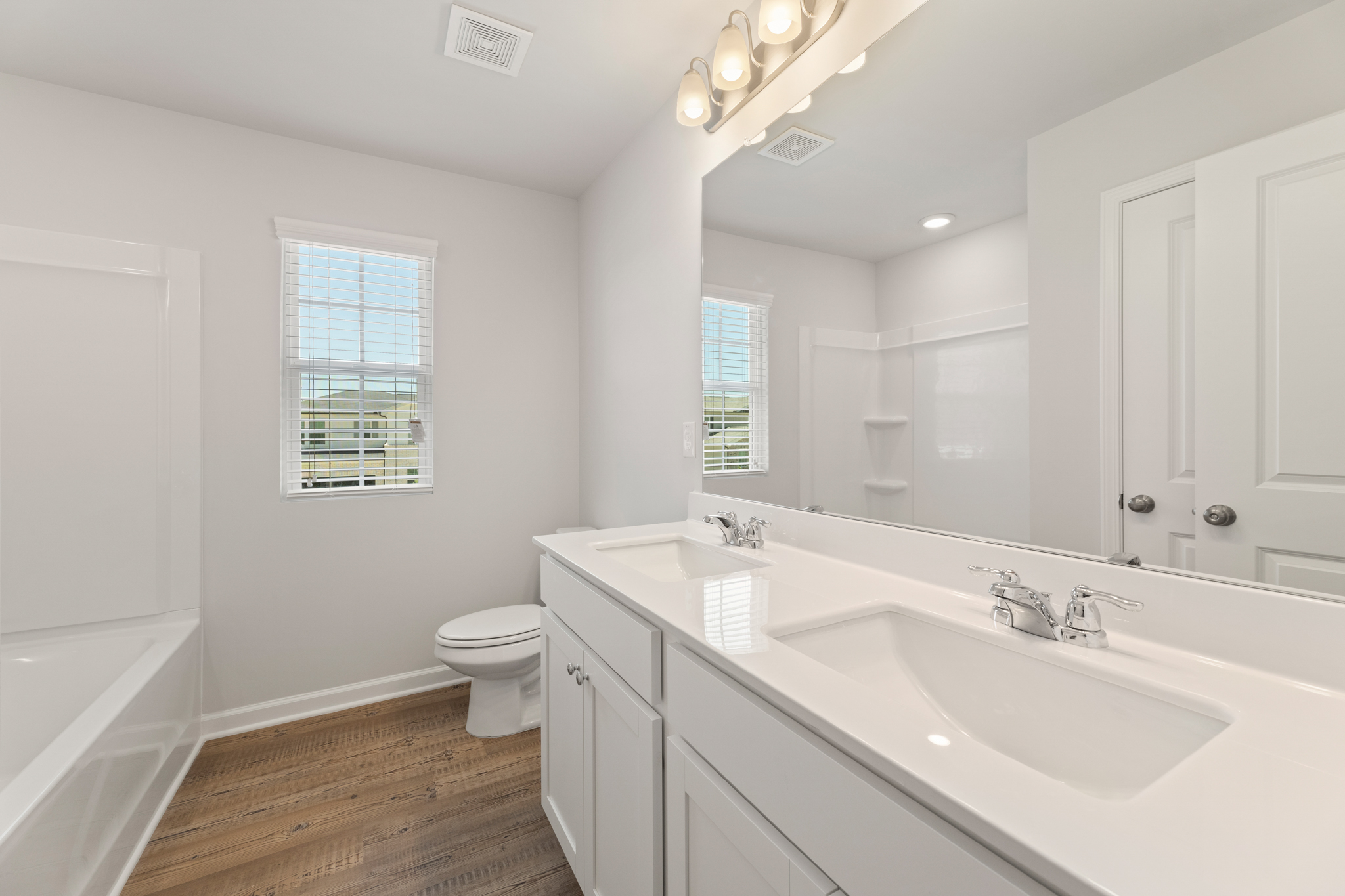 A bathroom with a tub sink and toilet.
