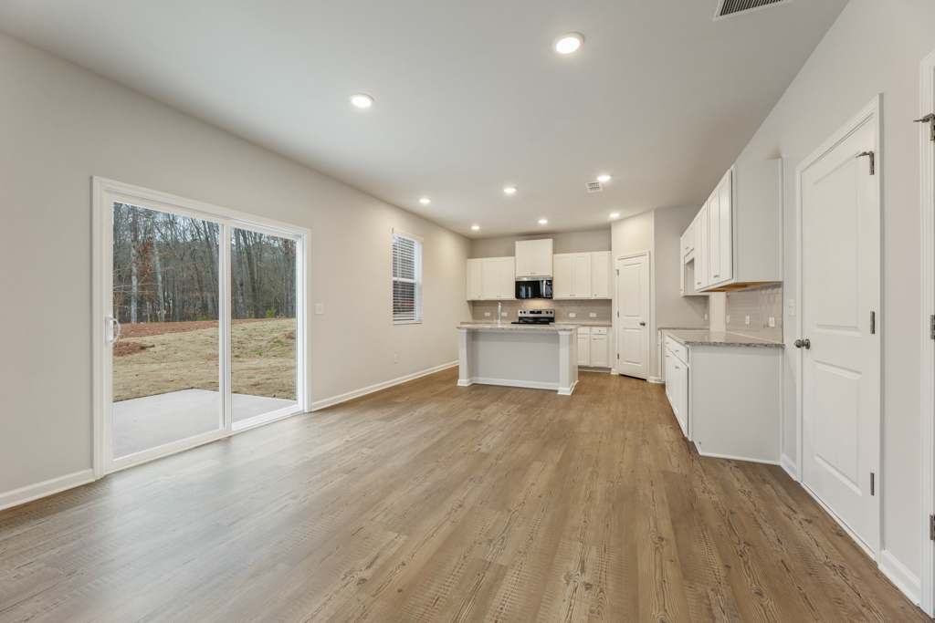 A large kitchen with white cabinets.