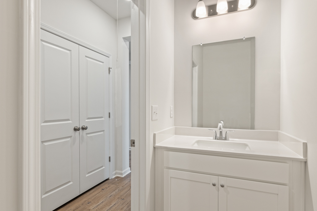 A bathroom with a mirror and sink.