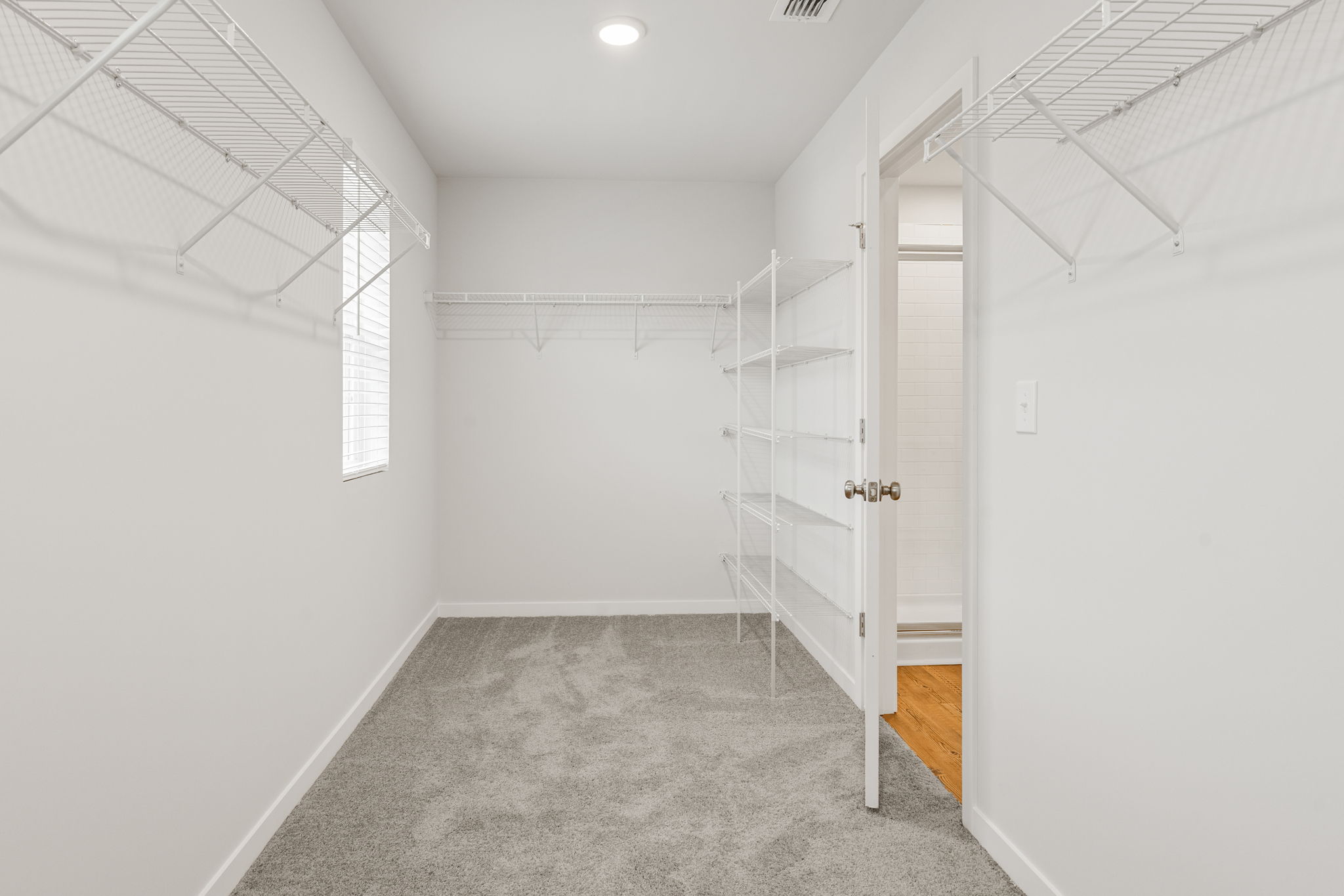A hallway with white walls.