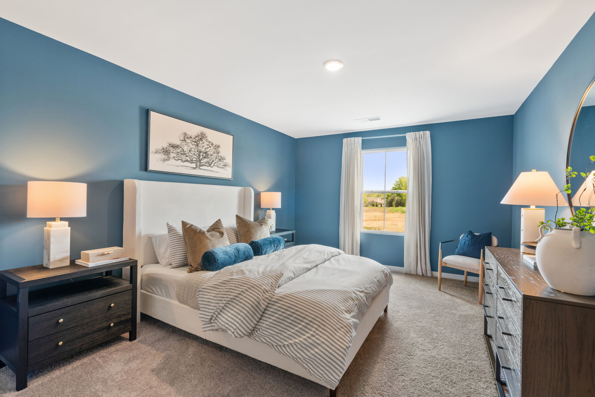 A bedroom with a bed and lamps.