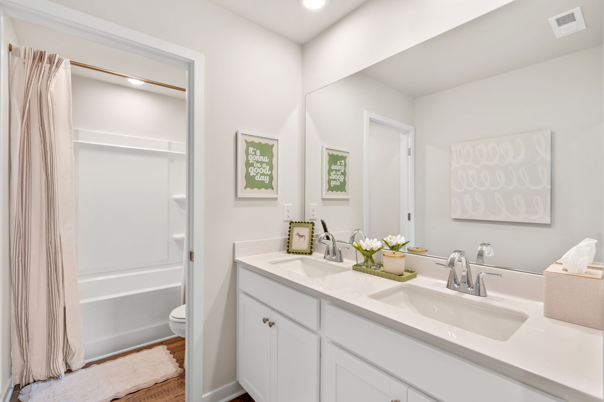A bathroom with a tub sink and toilet.