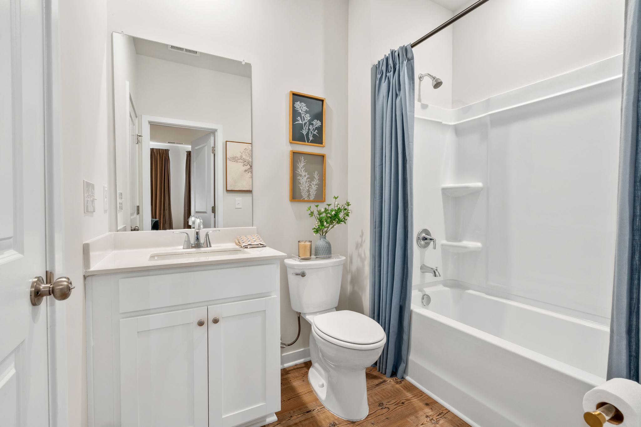 A bathroom with a tub toilet and sink.