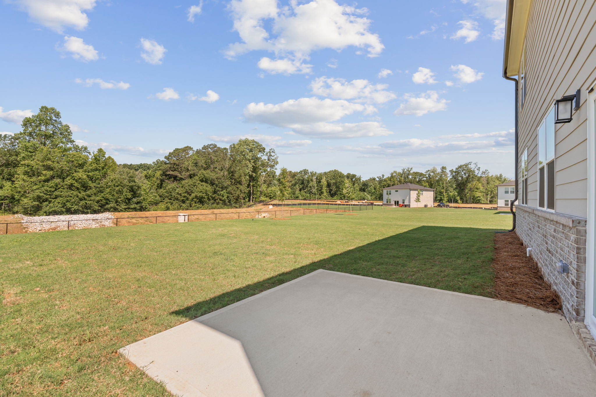 A grassy area with a building in the background.